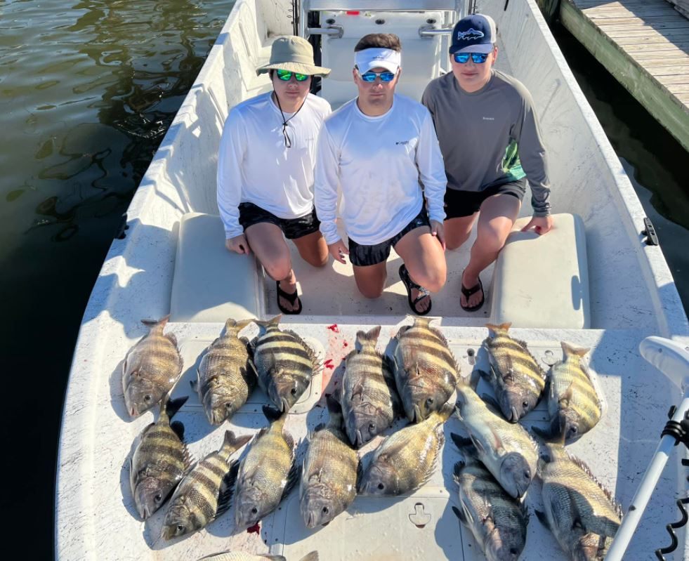 Three people enjoying a fishing trip in Gulf Shores
