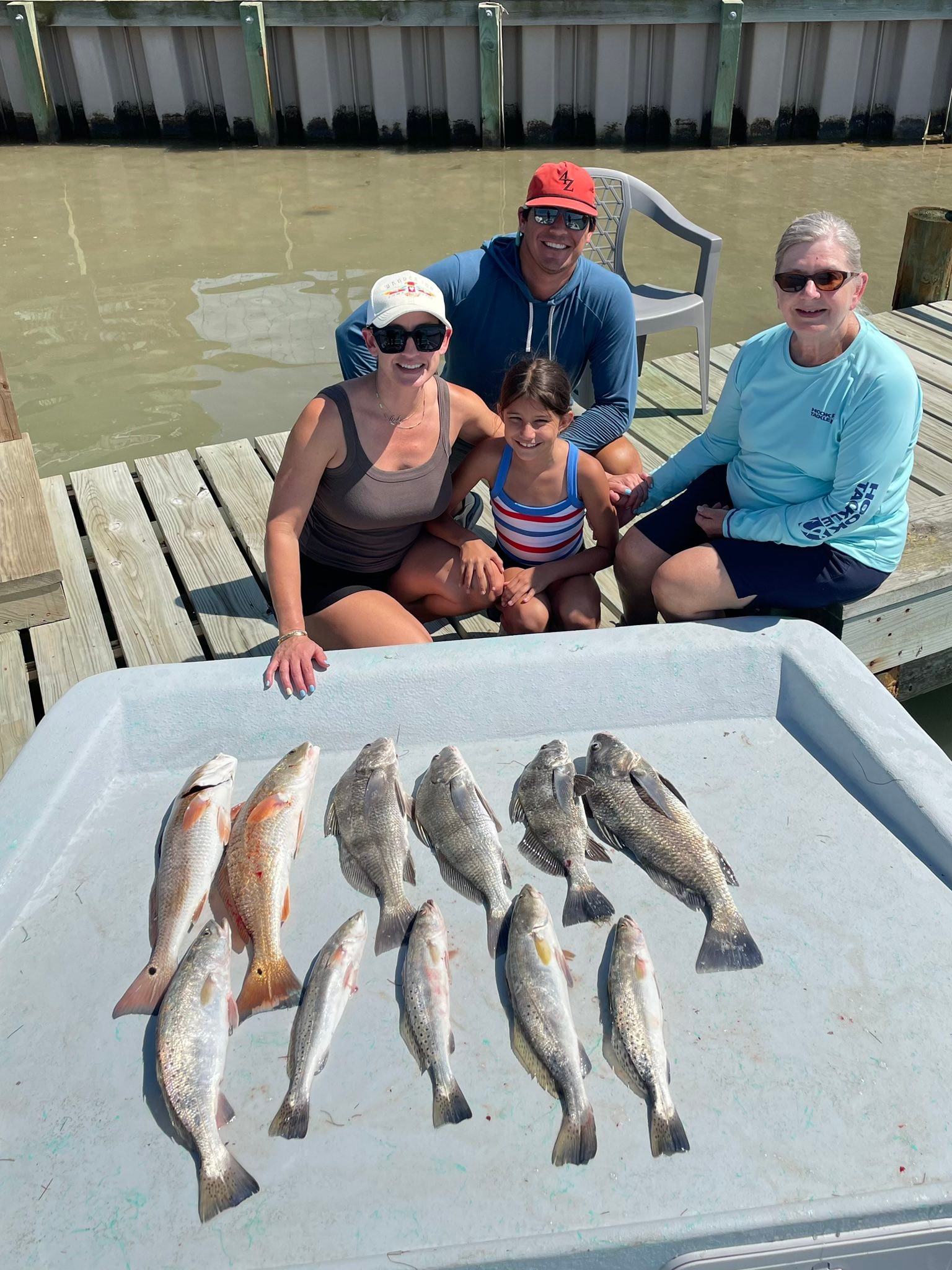 Fishing catch of Black Drum, Speckled Trout, and Redfish displayed on dock in Rockport TX