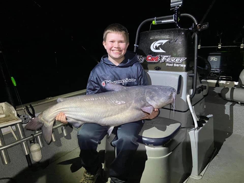 Angler proudly holding a large blue catfish in NC