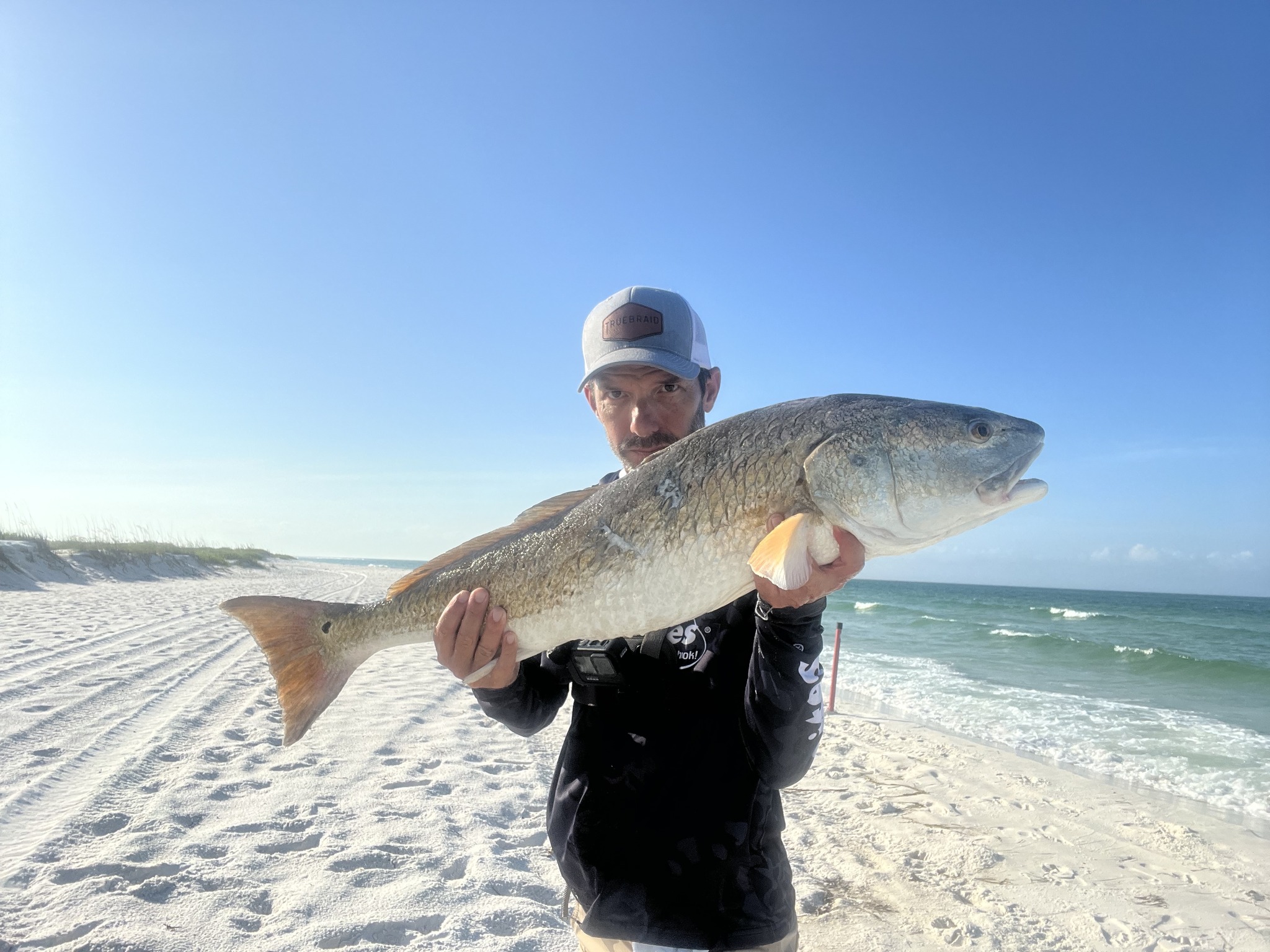Angler holding a huge redfish caught in FL