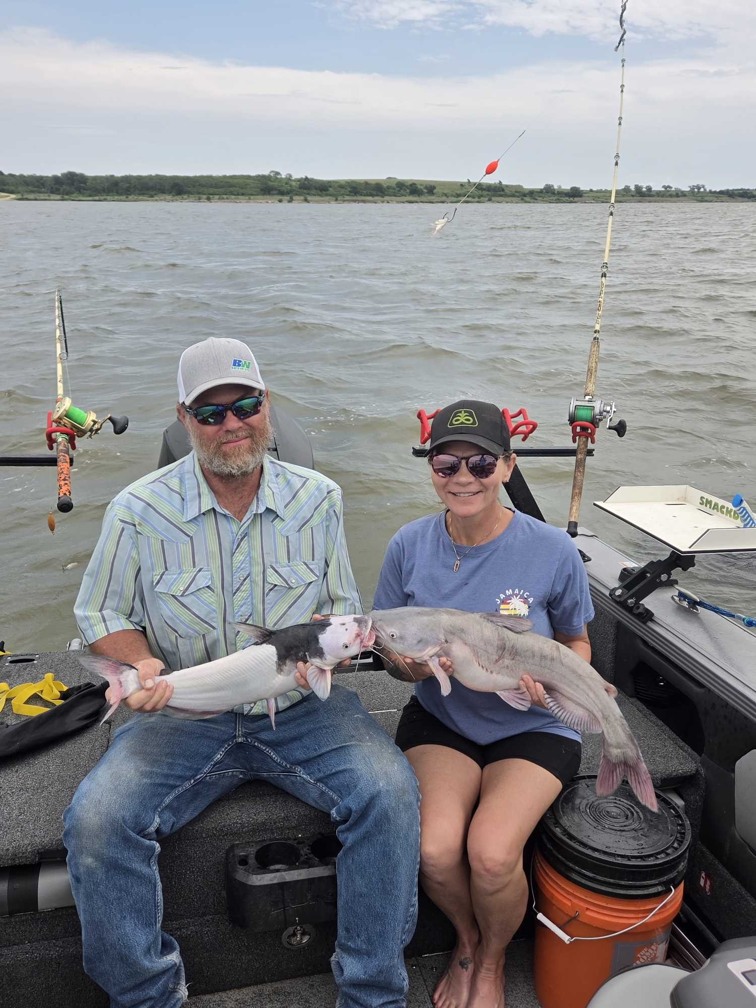 Two anglers displaying blue catfish caught during fishing tour in Manhattan Kansas