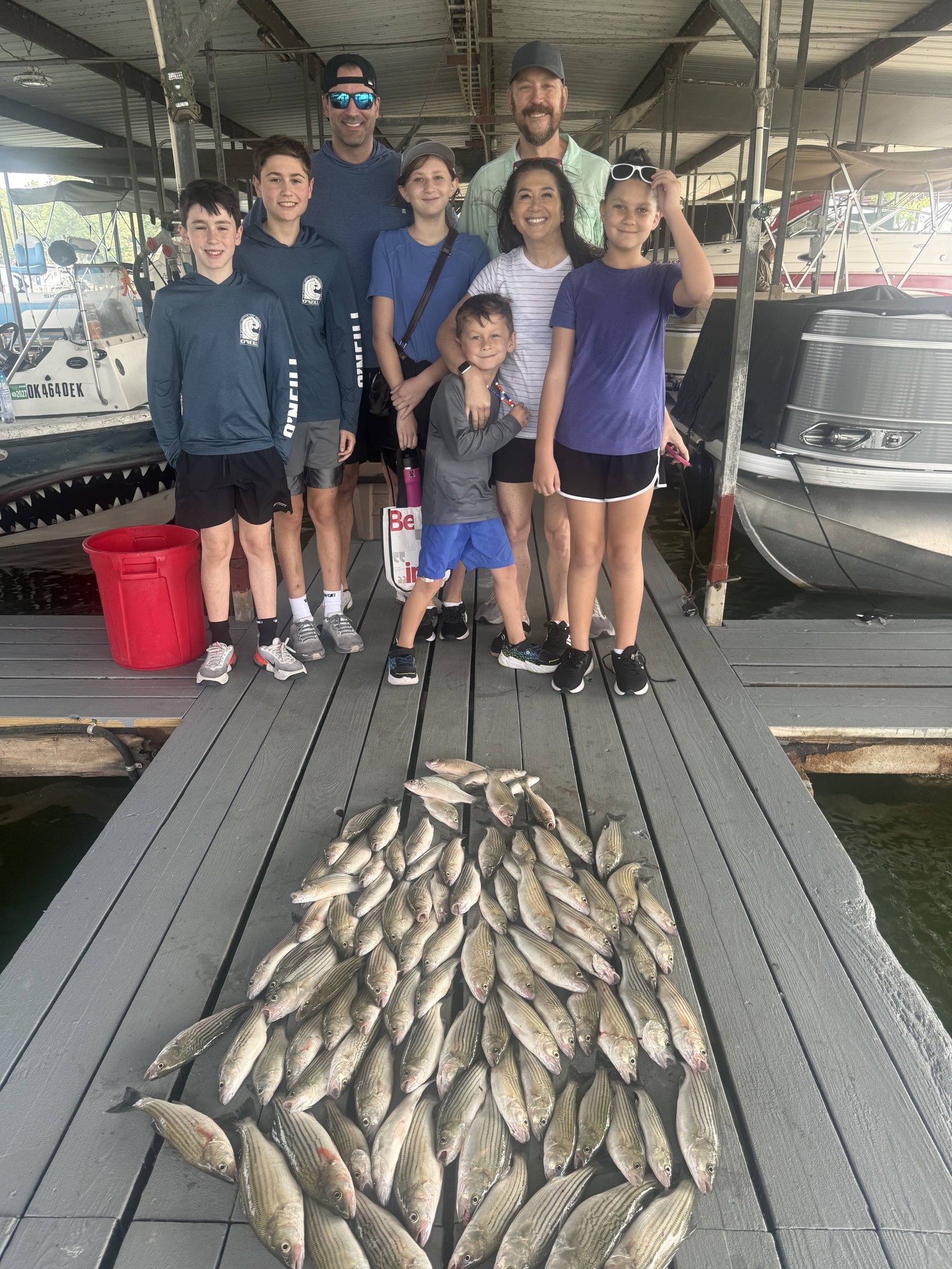 Large catch of fish displayed on wooden dock at marina in Pottsboro TX