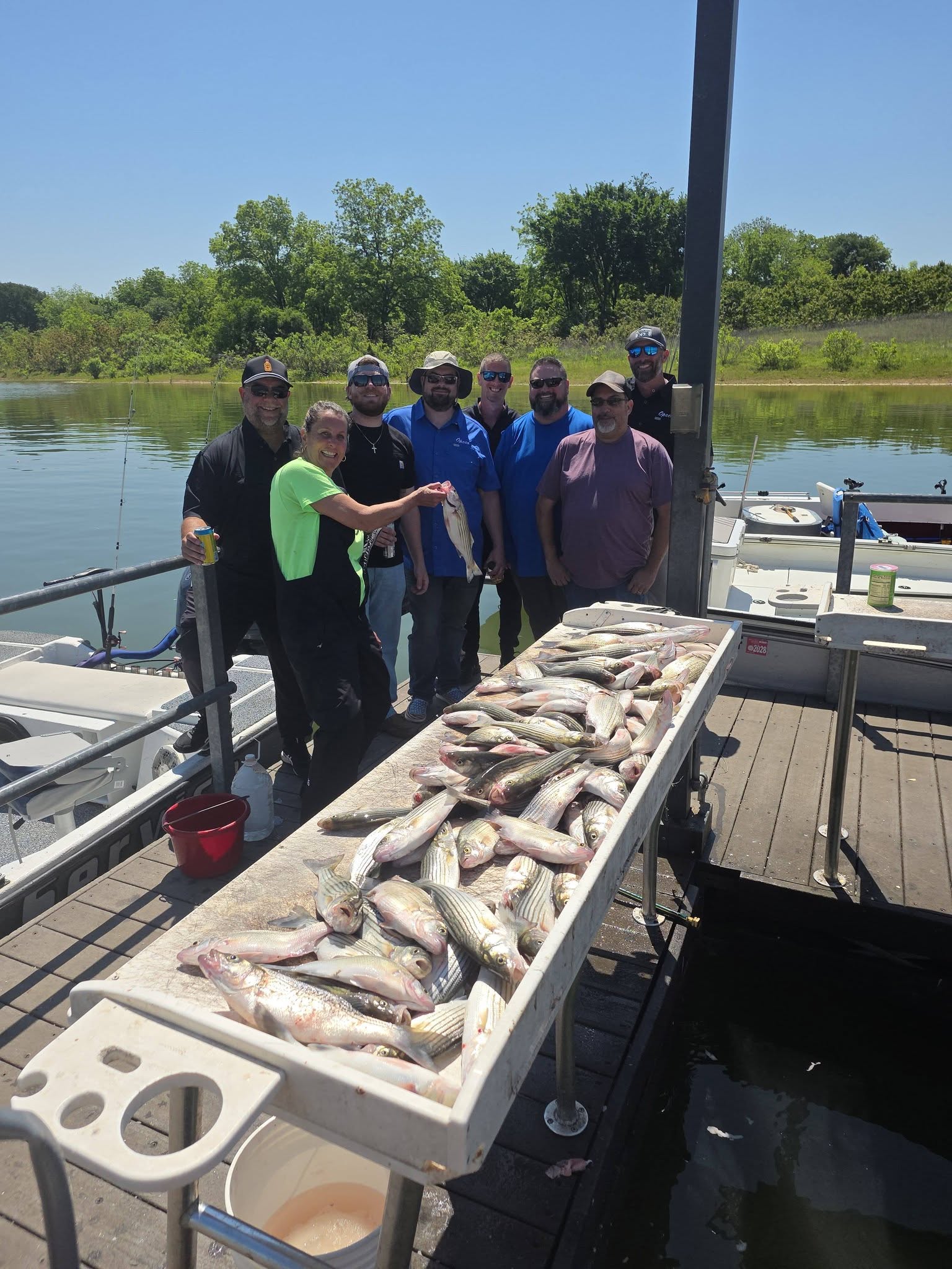Successful fishing trip in Pottsboro TX showing large catch of Flathead Grey Mullet displayed on boat deck