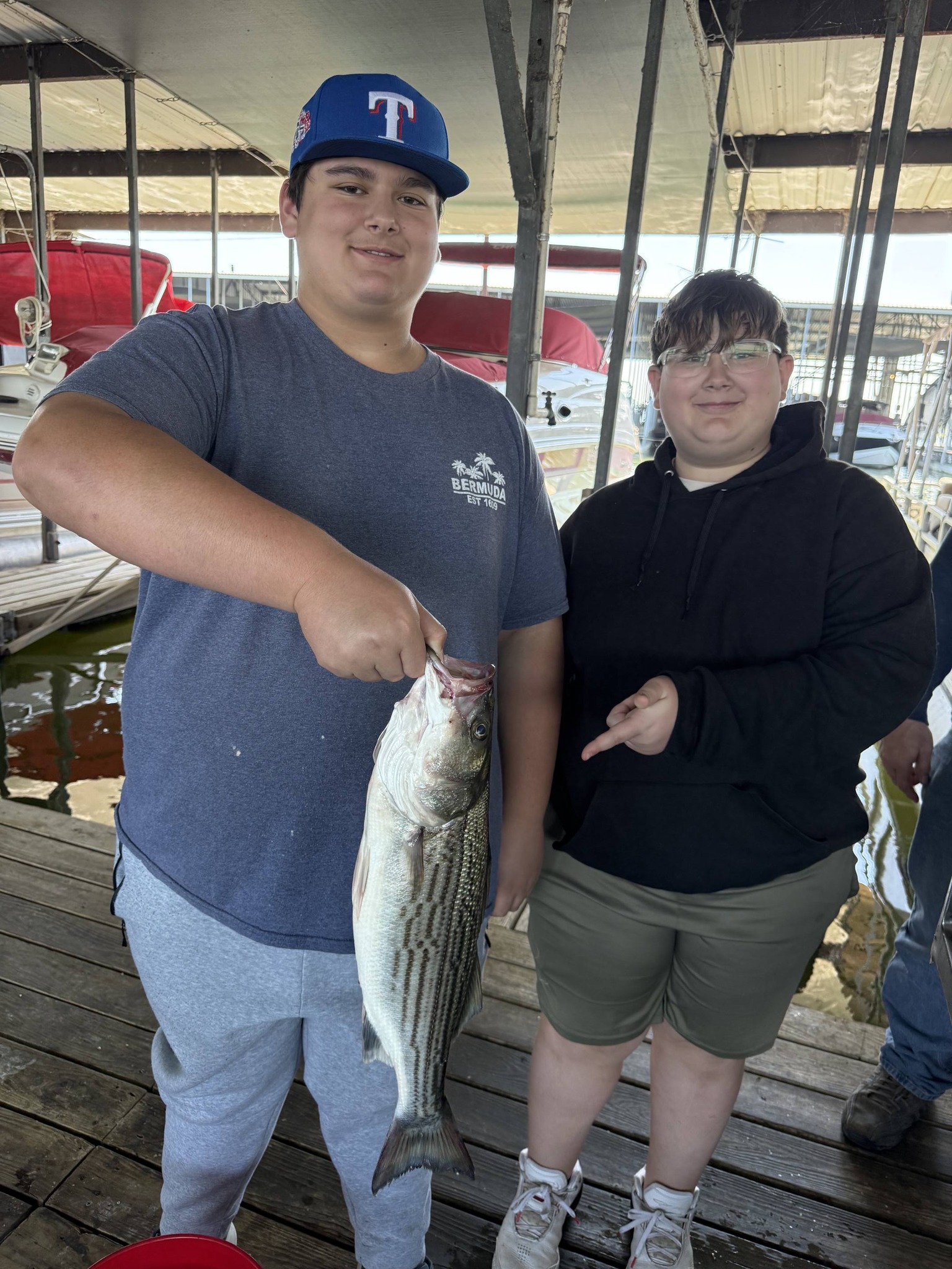 Freshly caught striped bass displayed on fishing dock in Pottsboro TX