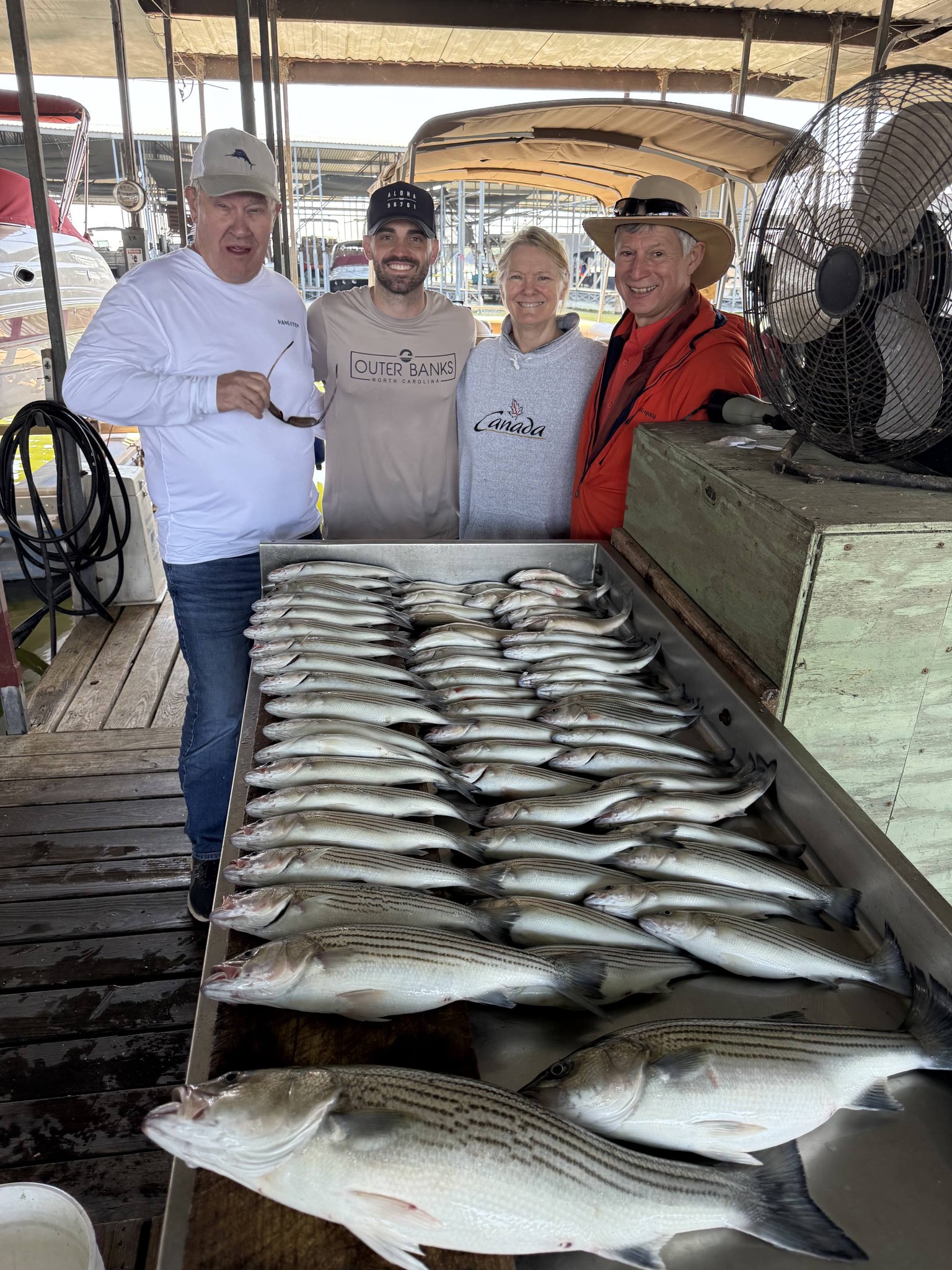 Large catch of striped bass displayed in boat after successful fishing trip in Pottsboro TX