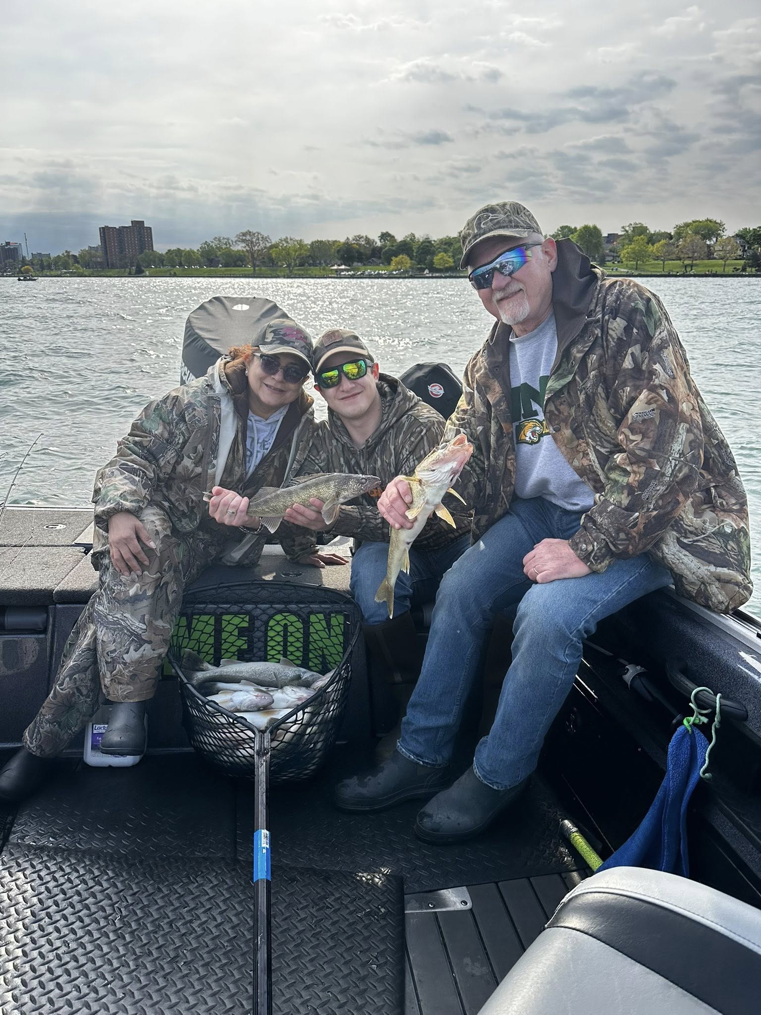 Successful walleye fishing trip on Detroit waters with full net of fresh caught fish