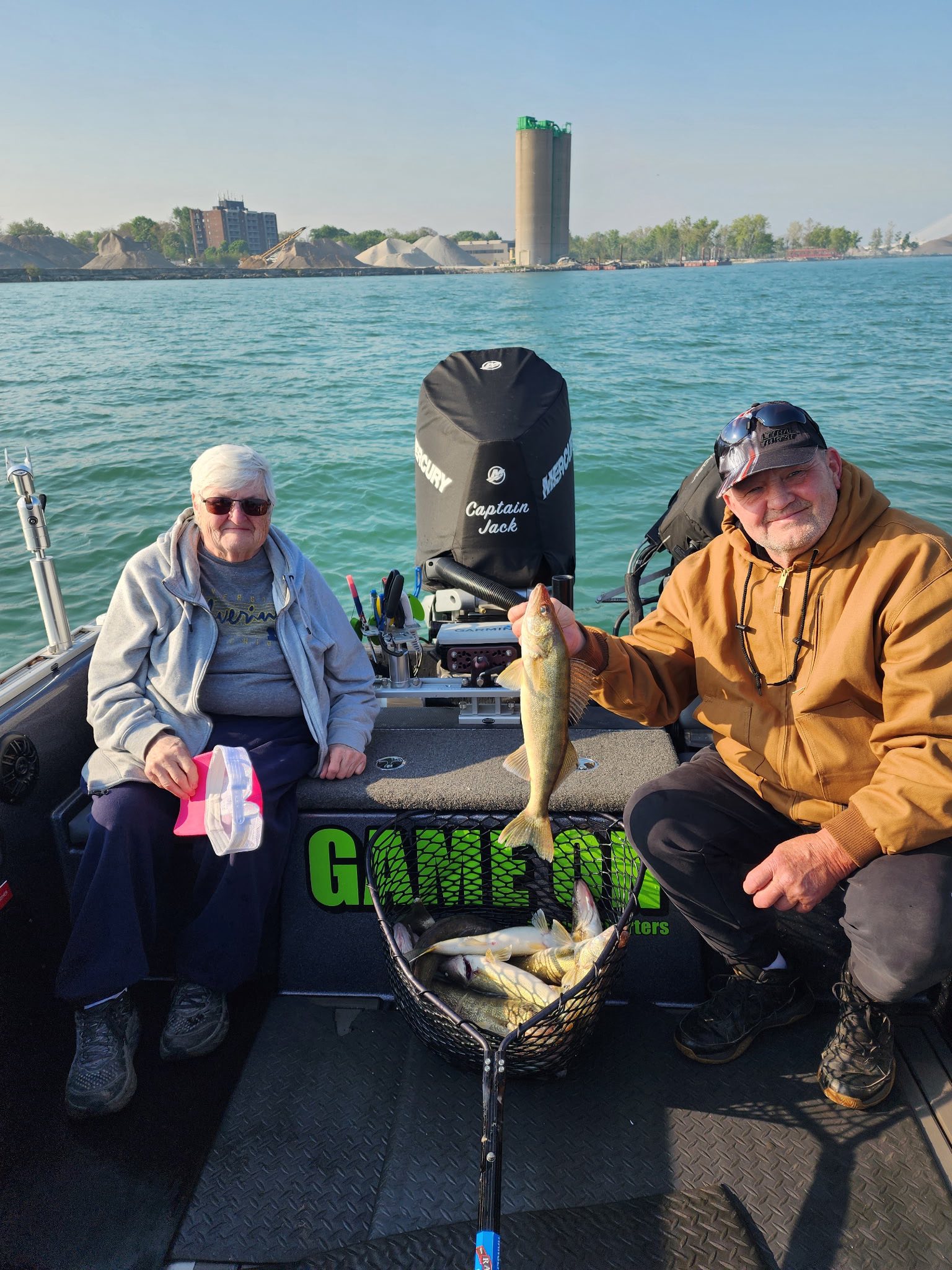 Successful walleye fishing trip on Detroit waters with fresh catch displayed in landing net