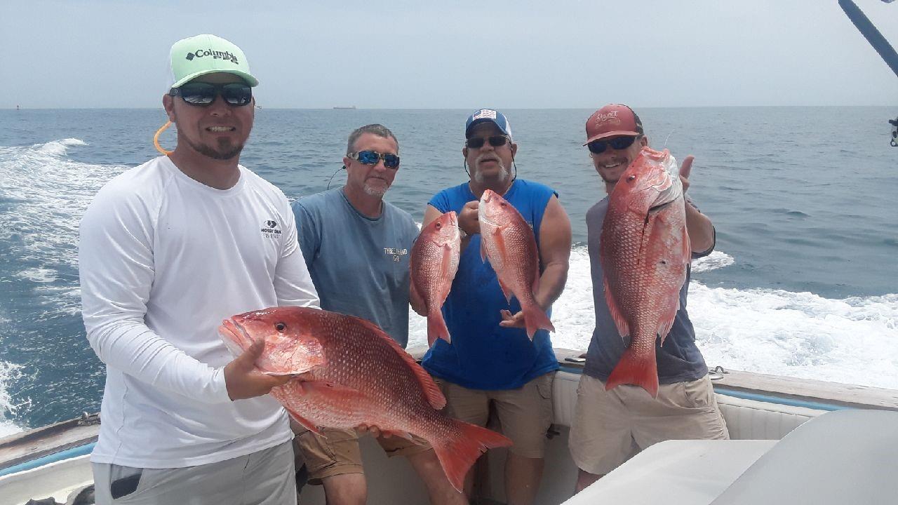 A group of 4 people enjoying a successful fishing trip in FL