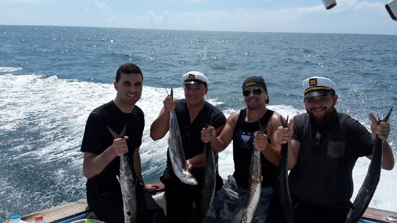 4 anglers with fishing rods posing for a photo at Port Orange