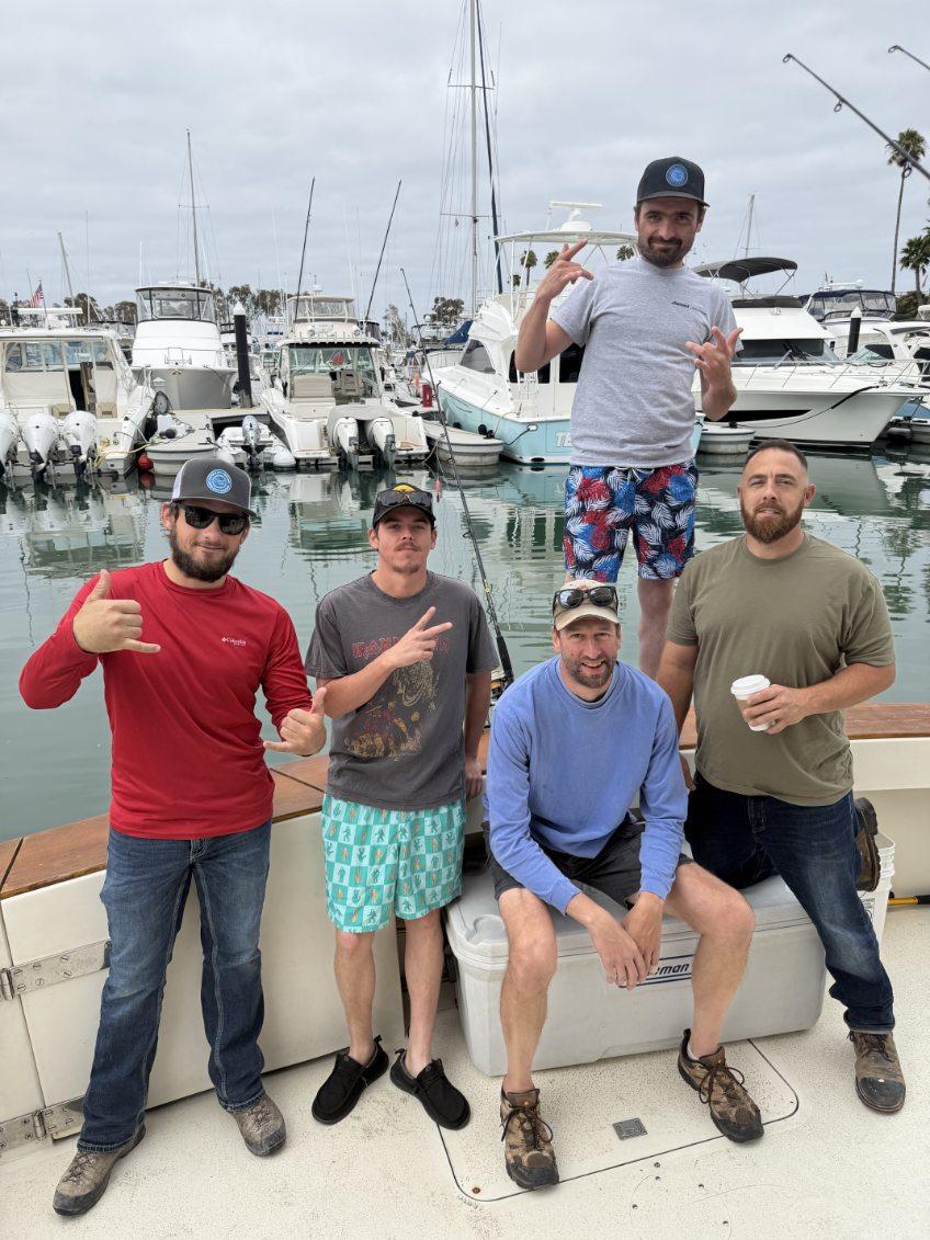 Group on fishing boat at Dana Point CA marina with boats in background
