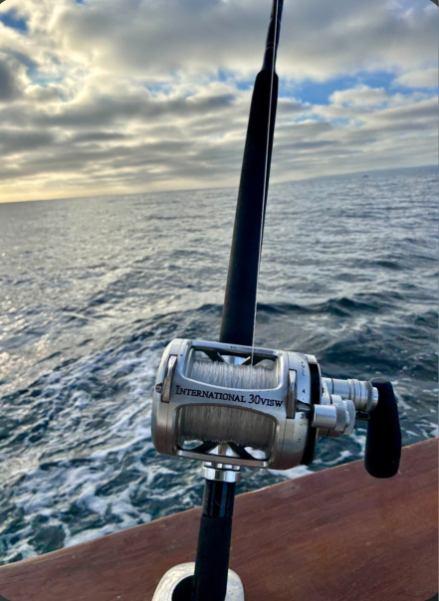Fishing reel mounted on rod over ocean waters near Dana Point CA