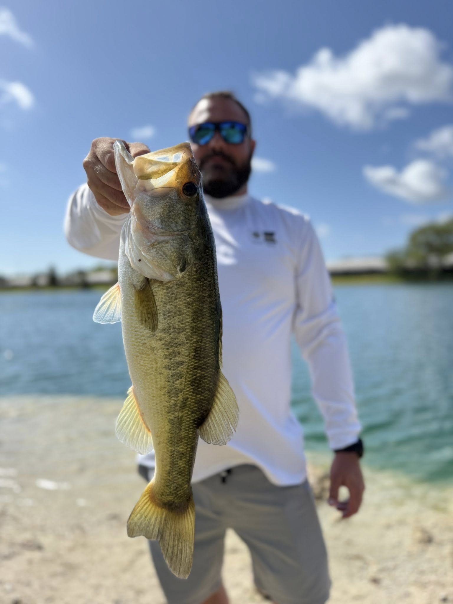 Bass fishing catch held up displaying successful fishing in Miami FL