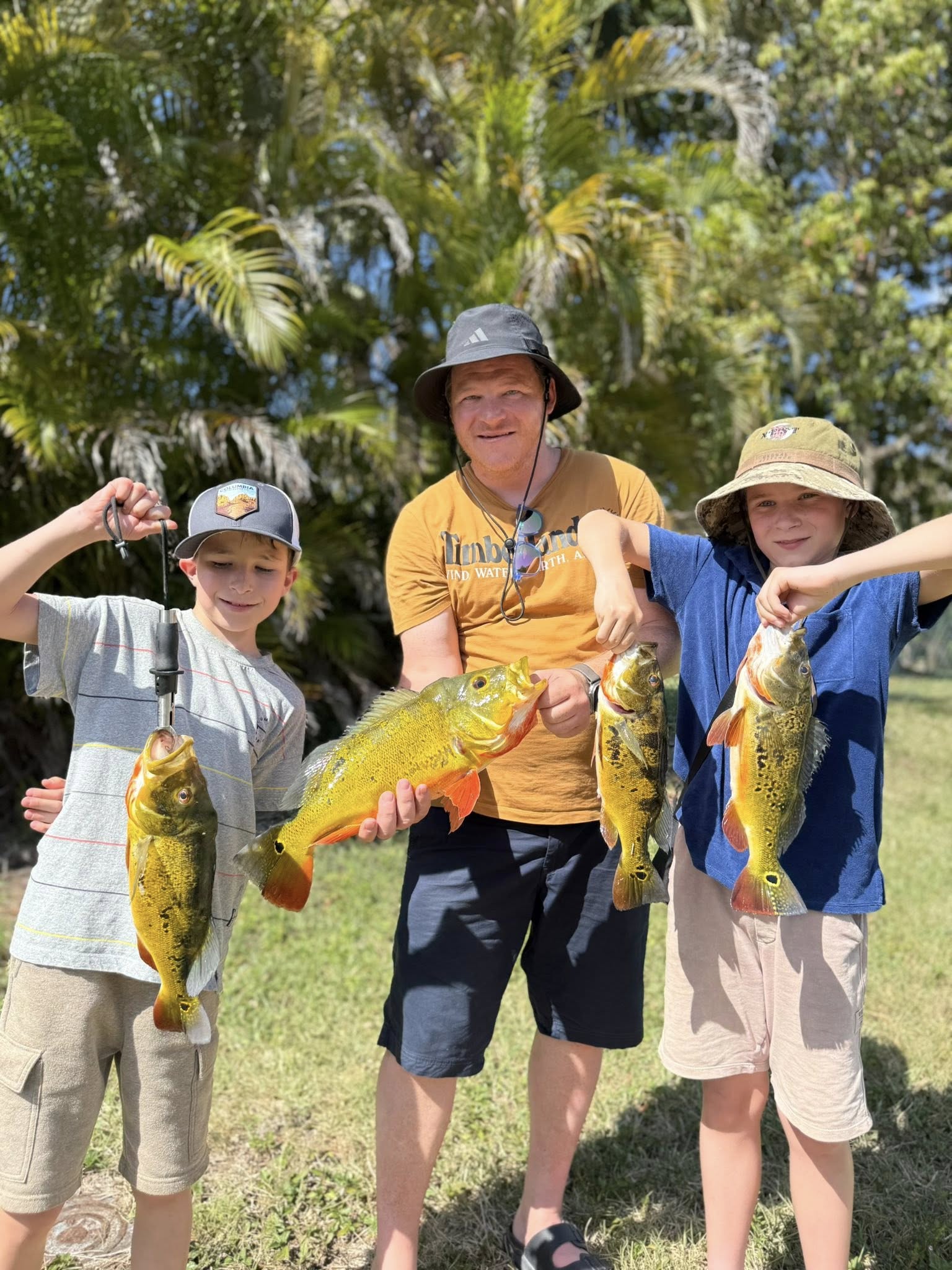 Successful peacock bass fishing trip in Miami FL with four caught fish displayed