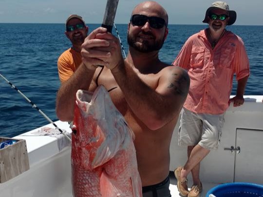 A group of 3 people fishing at Panama City Beach