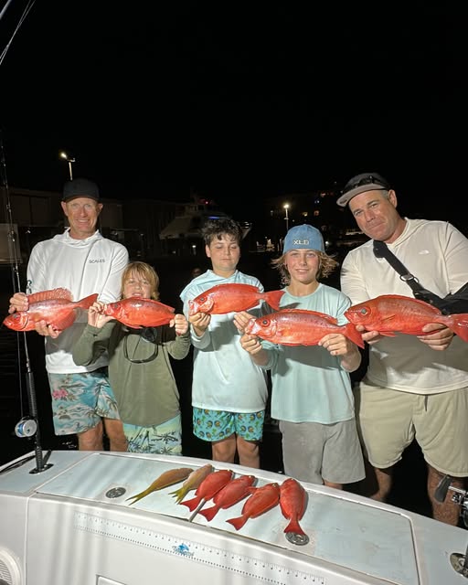 Night fishing trip in Pompano Beach FL showing fresh caught red snapper displayed on boat deck