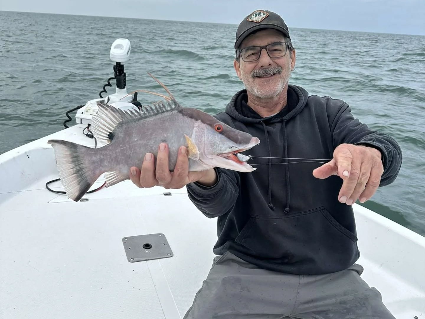 Inshore fishing charter boat targeting snook, redfish, and trout in shallow waters