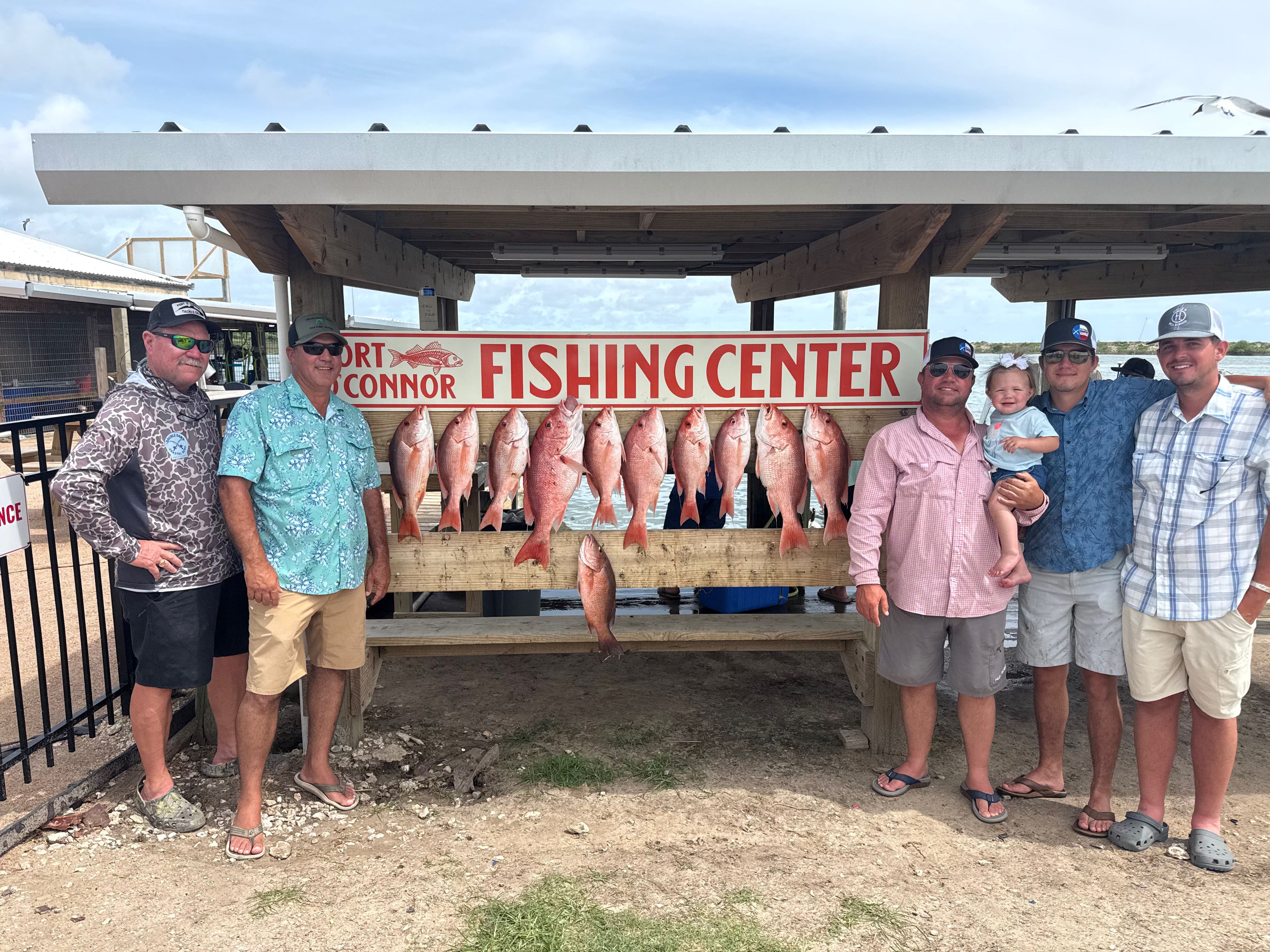 Red snapper fishing catch displayed at Port O'Connor TX fishing center with successful anglers