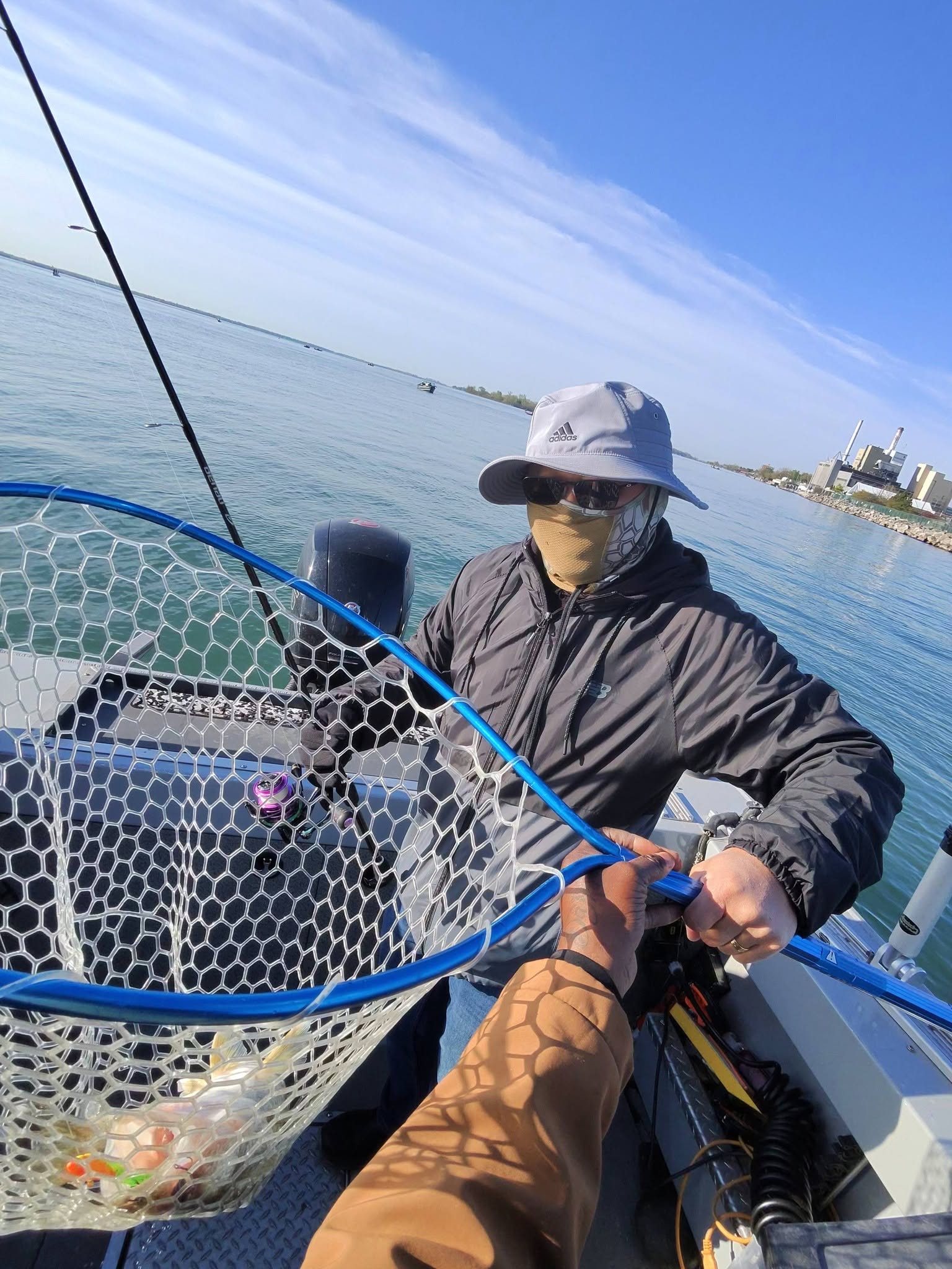 Fishing net on boat in Detroit MI waters with urban skyline visible in background