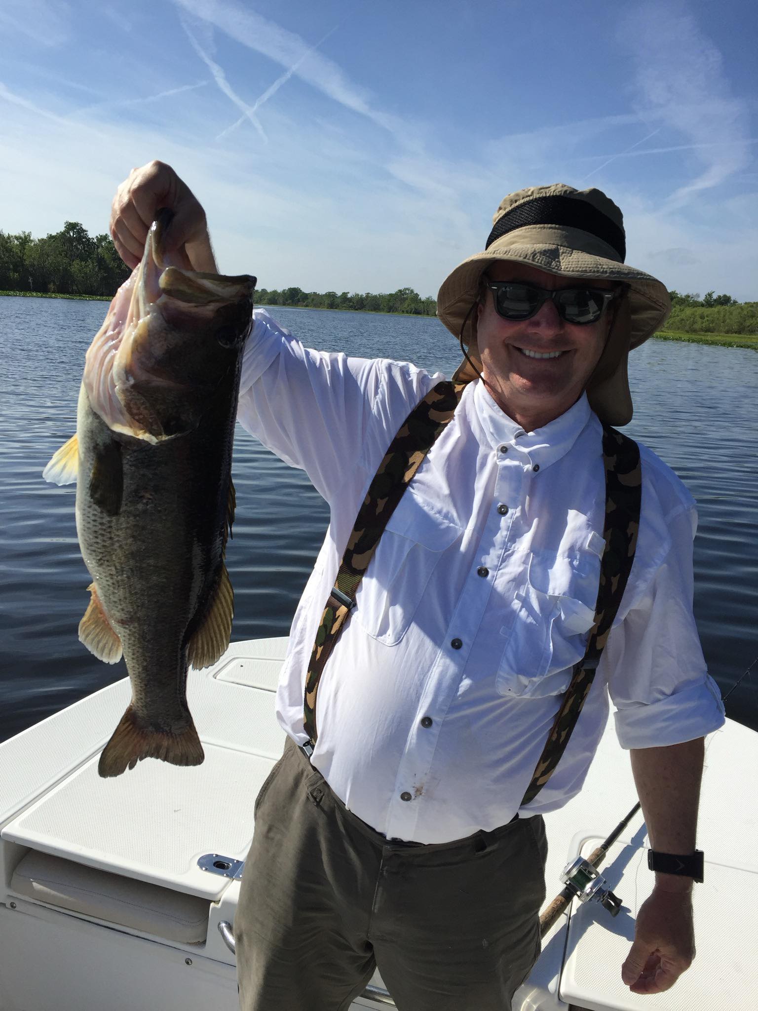 Angler holding large bass fish on boat in Alba TX lake
