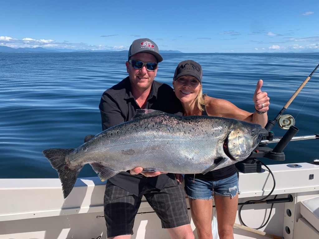 Chinook salmon fish caught by two people in BC