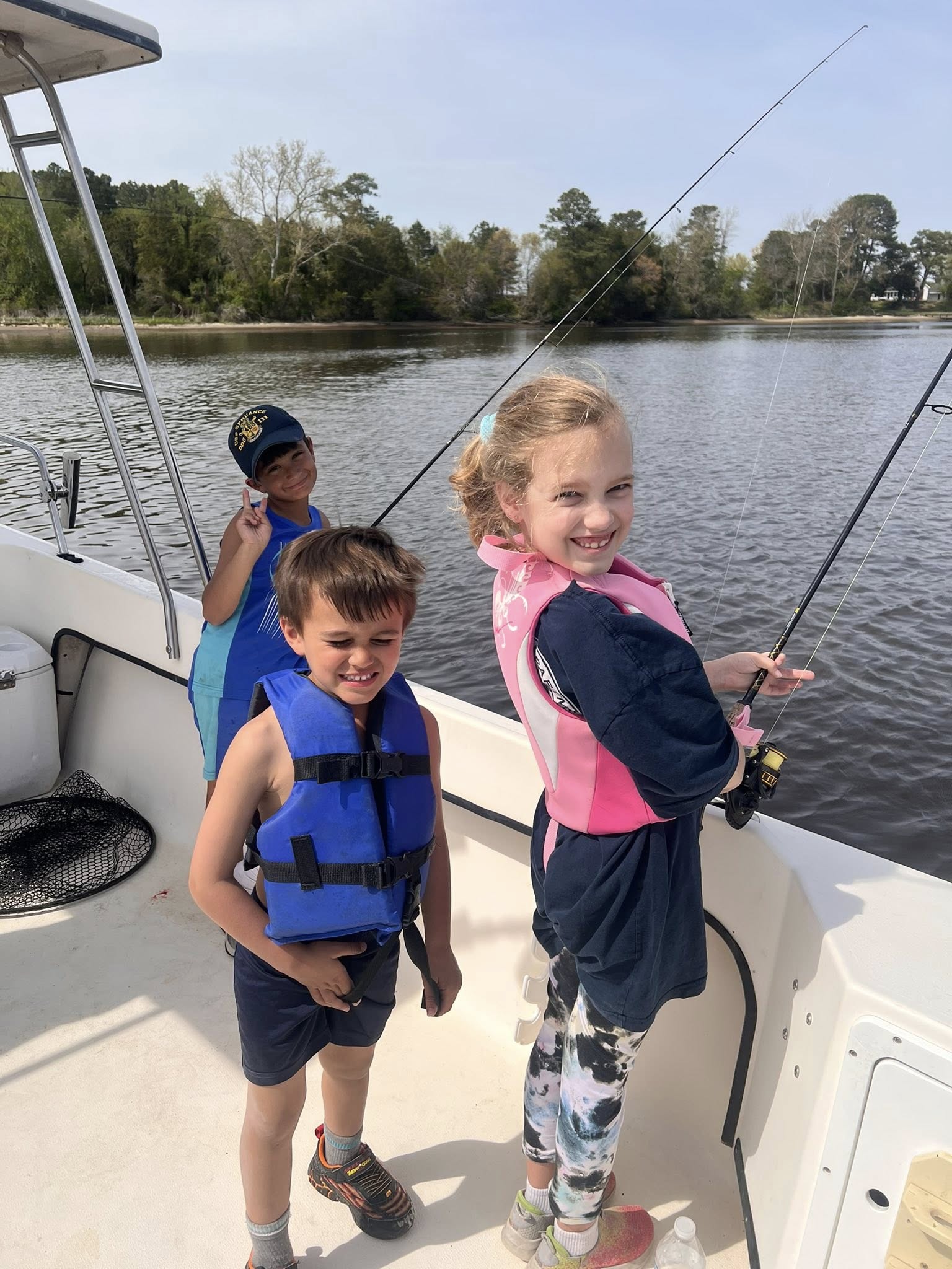 Three people enjoying a fishing cruise in Salisbury