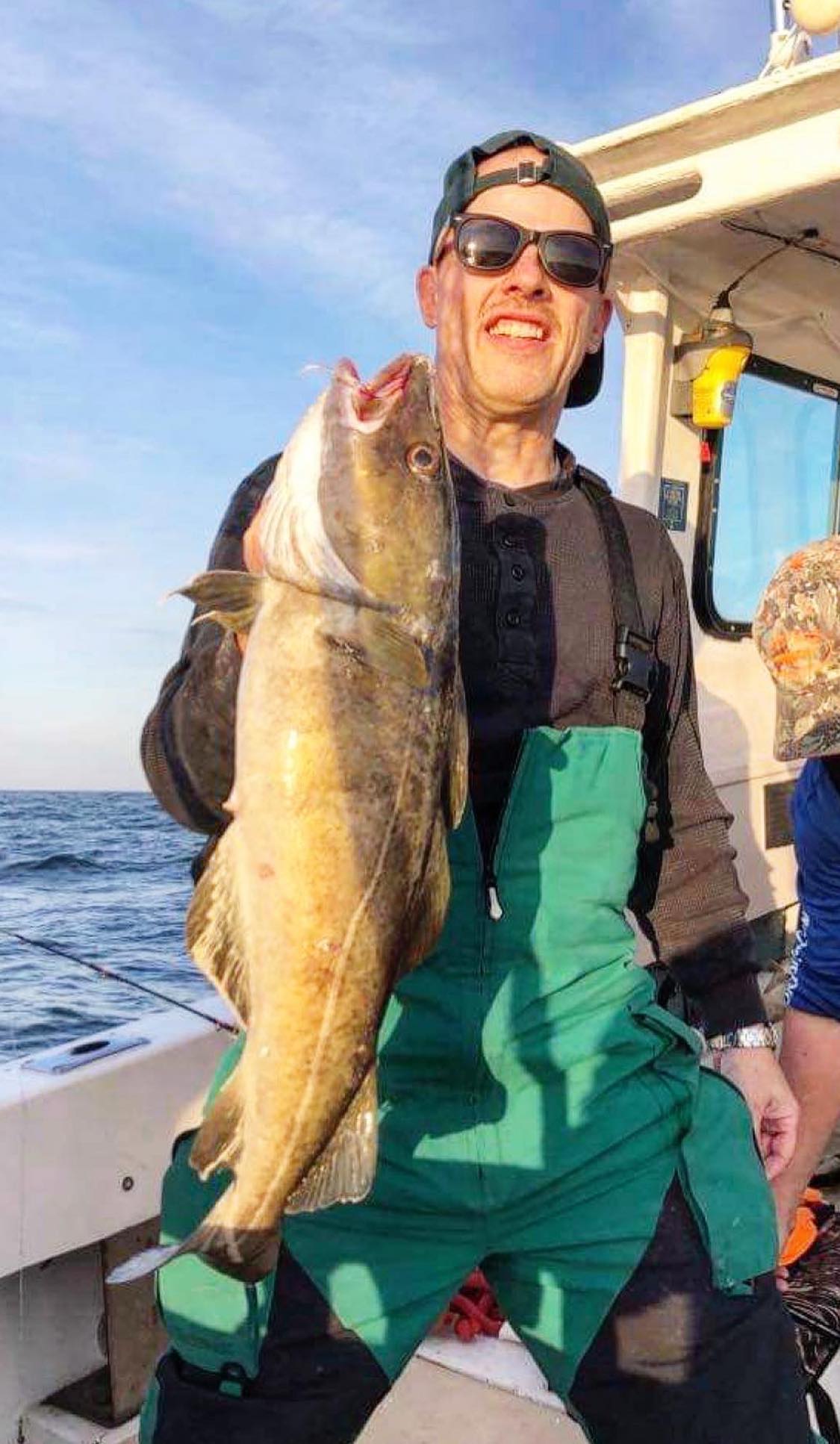 A person holding a big fish in Groton
