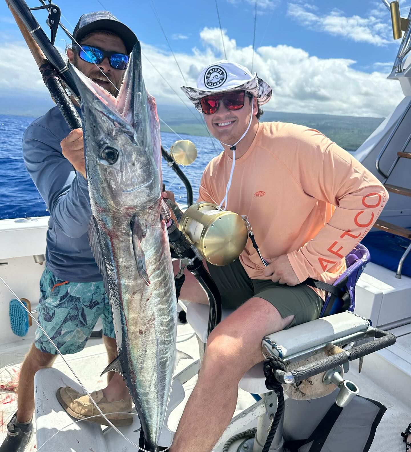 Offshore fishing boat on Kona coast waters targeting marlin, tuna and mahi mahi during sunset