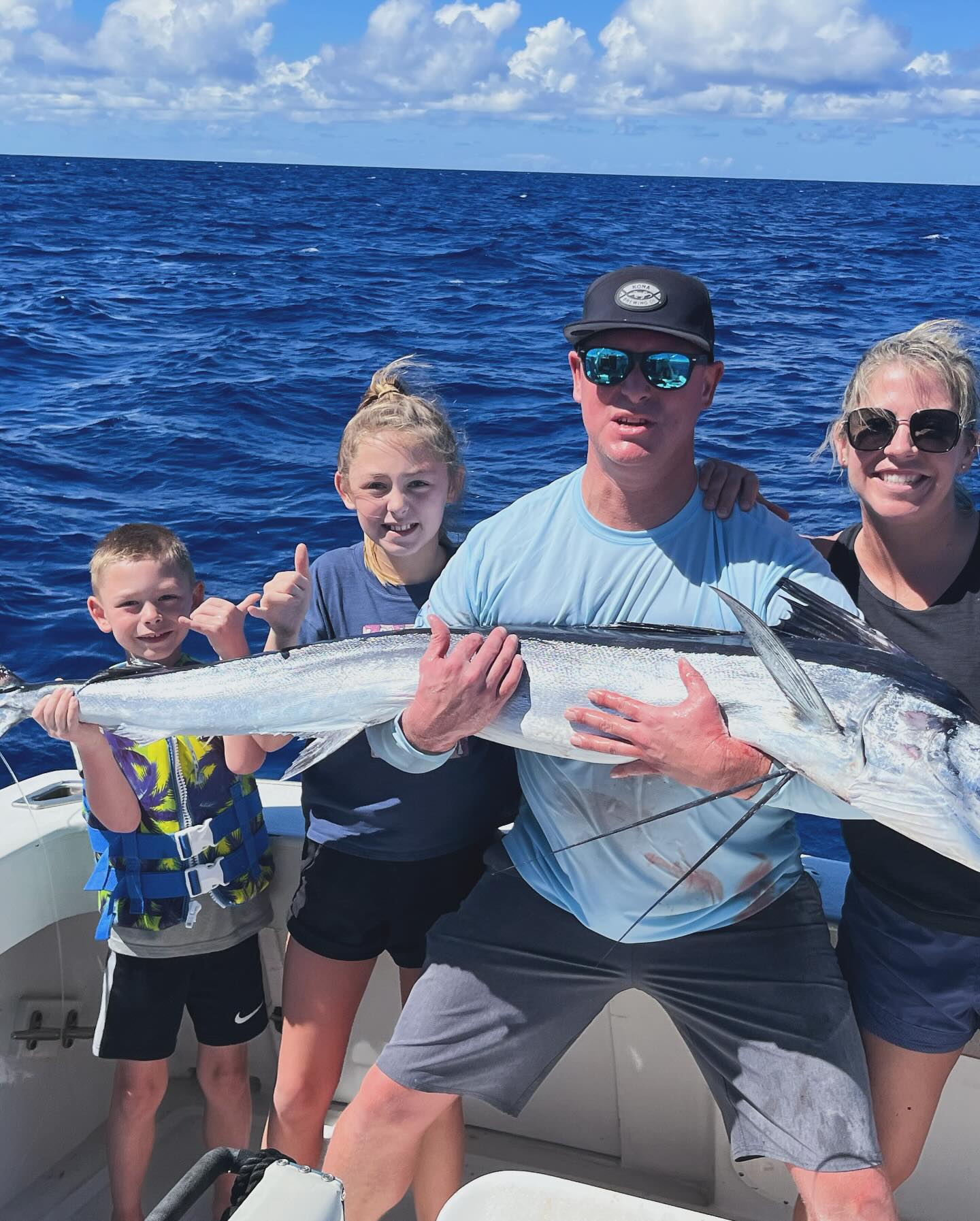 Half Day Sunset Kona Fishing Charter boat on ocean targeting marlin, mahi mahi, and tuna
