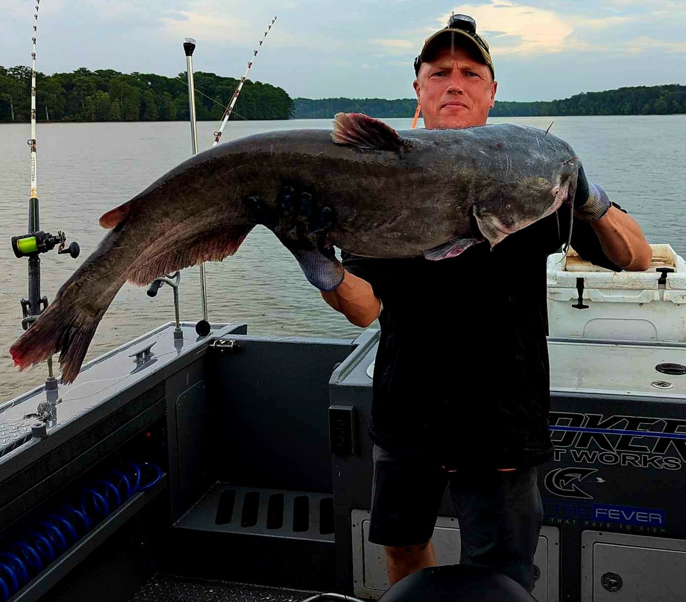 A person fishing in Hopewell, holding a 35-inch fish.
