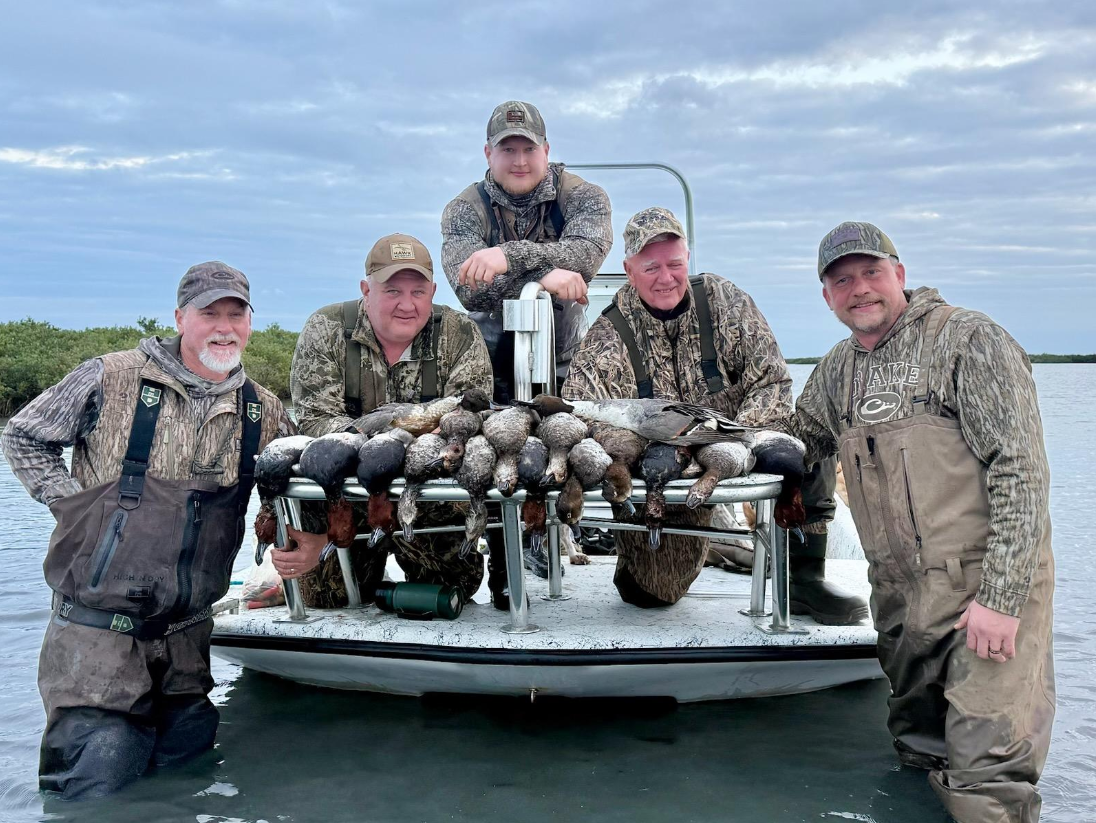 Five people enjoying fishing and hunting at South Padre Island