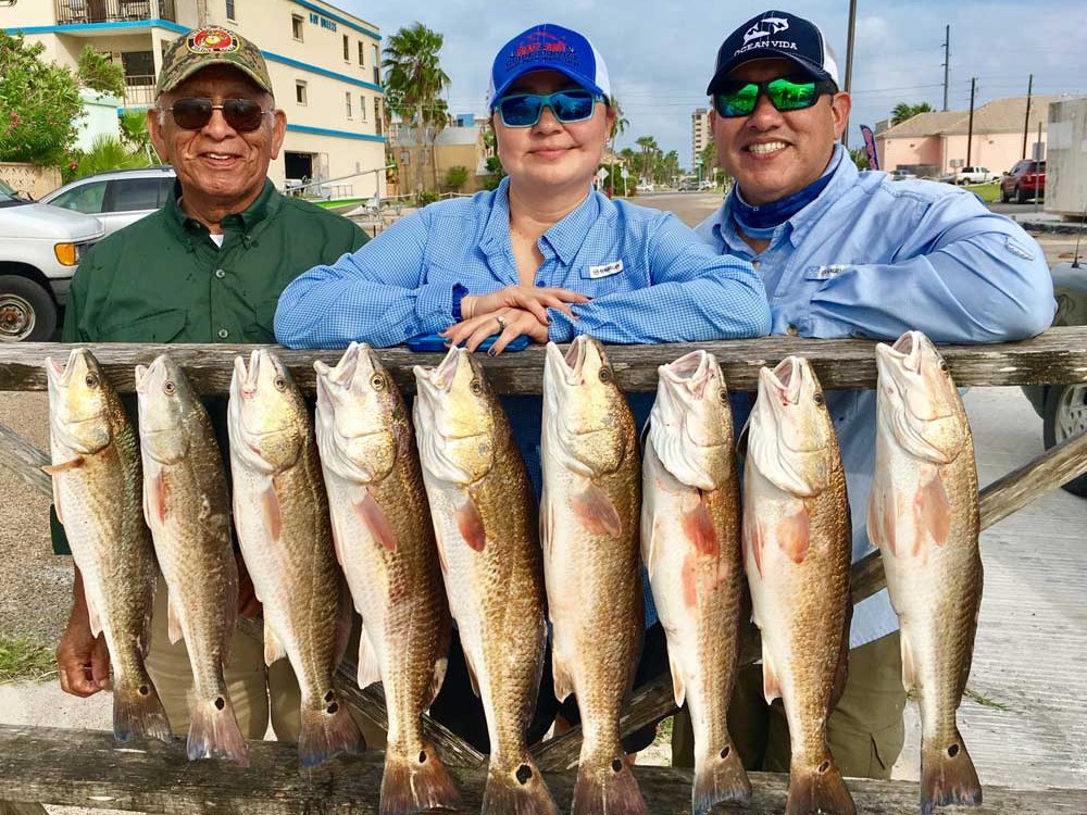Three anglers bay fishing for redfish and trout on South Padre Island inshore waters