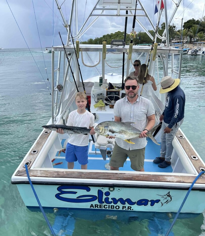 Fishing charter boat displaying caught Crevalle Jack and Great Barracuda in Dominicus waters