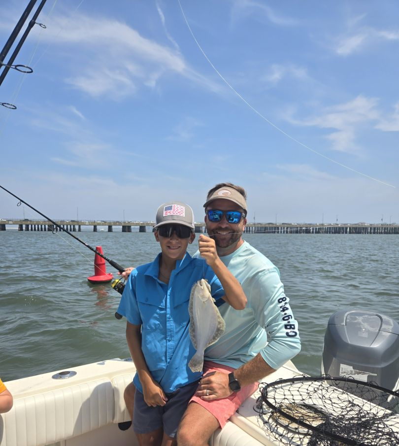Two people fishing in the ocean at Ocean City