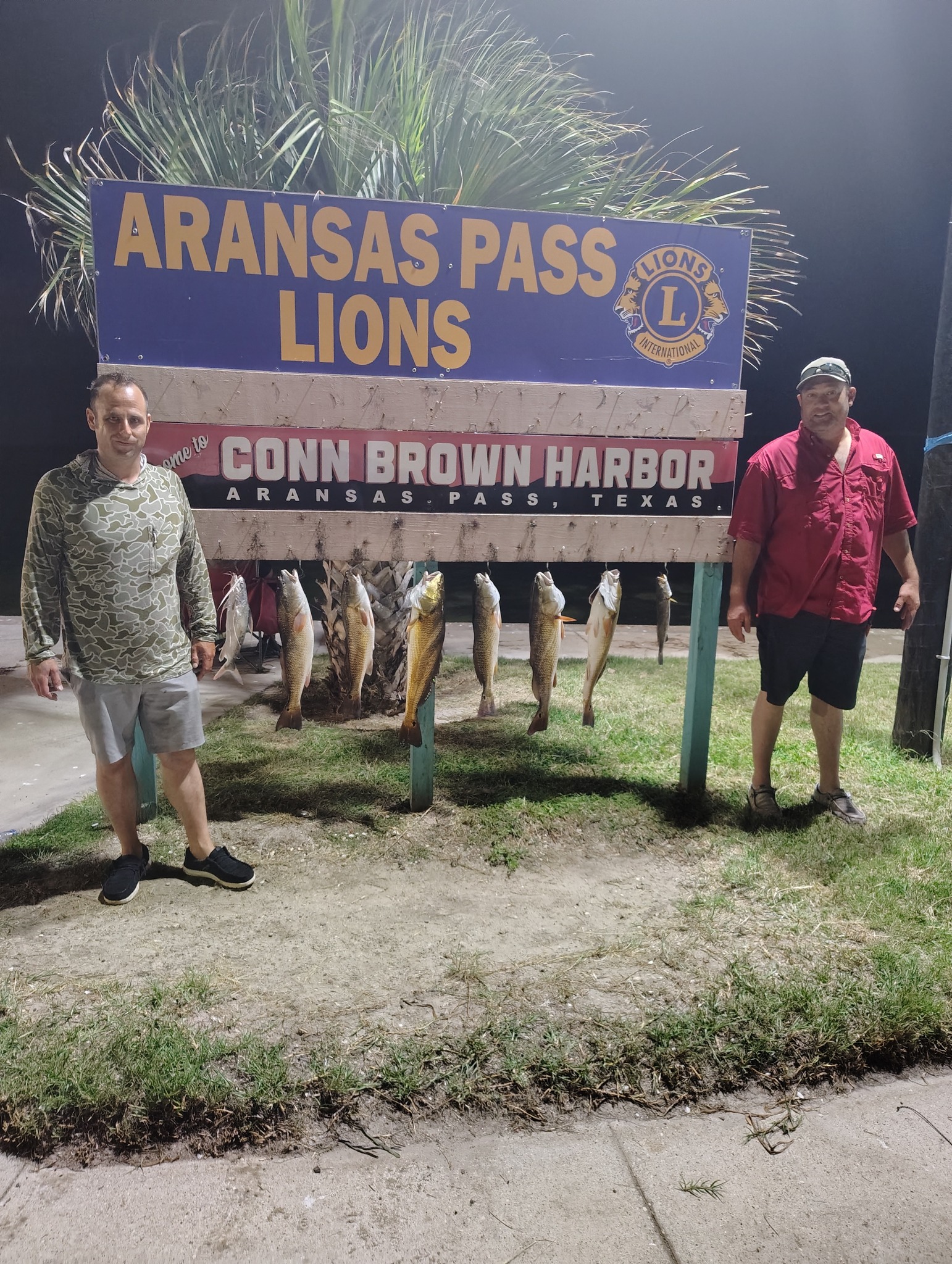 Successful redfish fishing trip displaying catch at Conn Brown Harbor in Aransas Pass, Texas