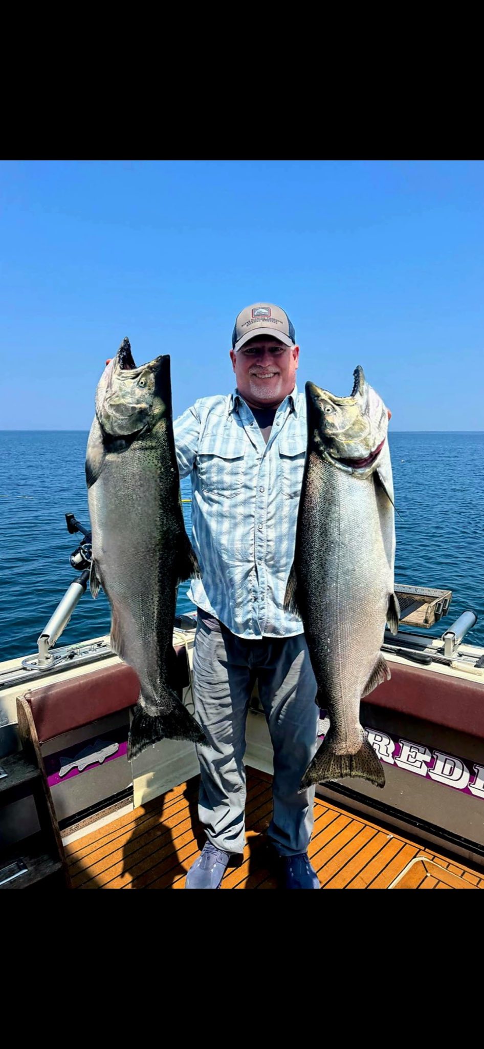 Two large Chinook salmon held on fishing boat in Olcott NY waters