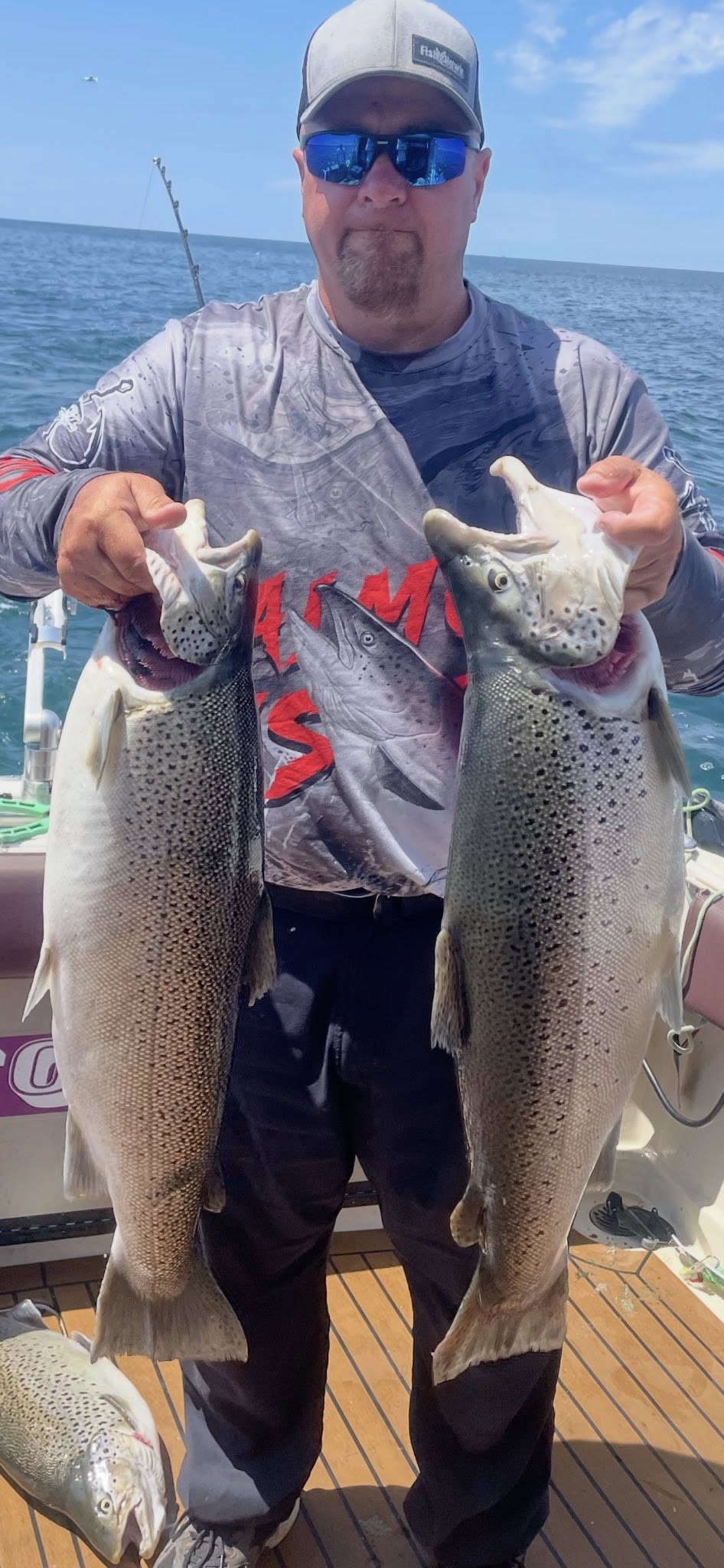 Two rainbow trout caught fishing in Olcott NY displayed on boat deck
