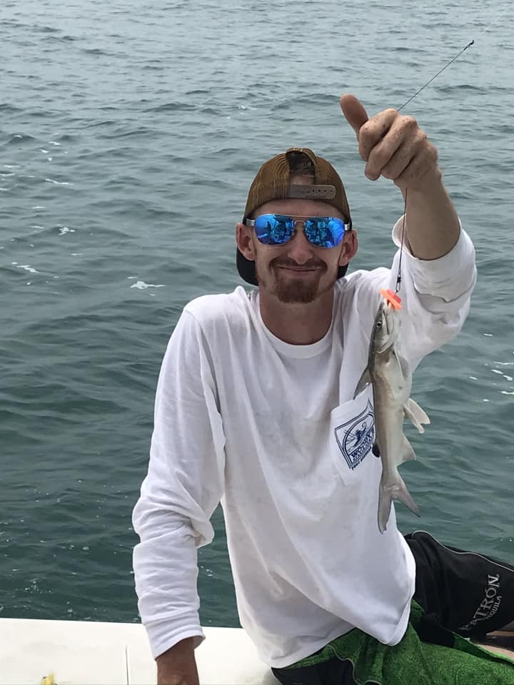An angler holding a hardhead sea catfish caught in TX