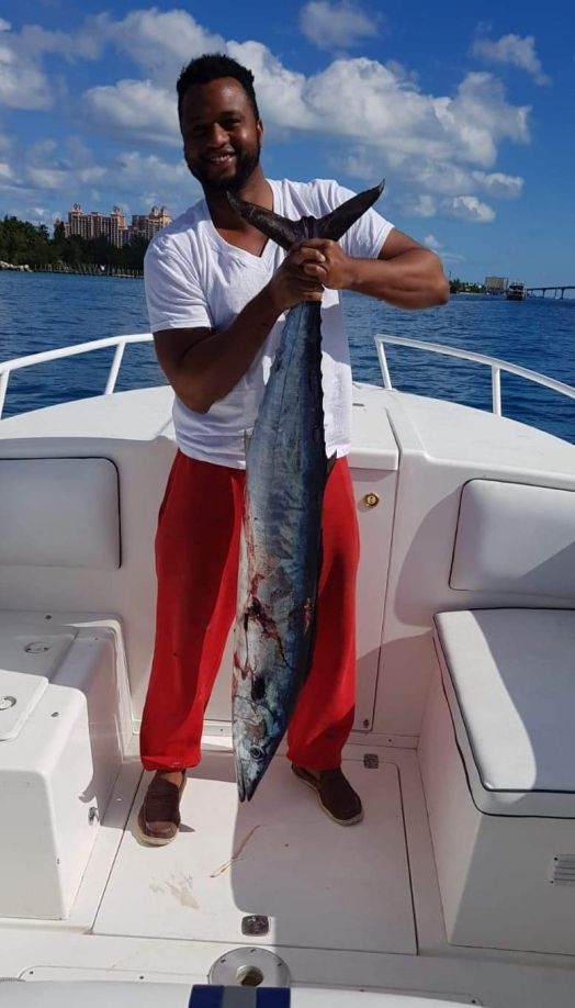 1 fisherman reeling in a big catch in Nassau