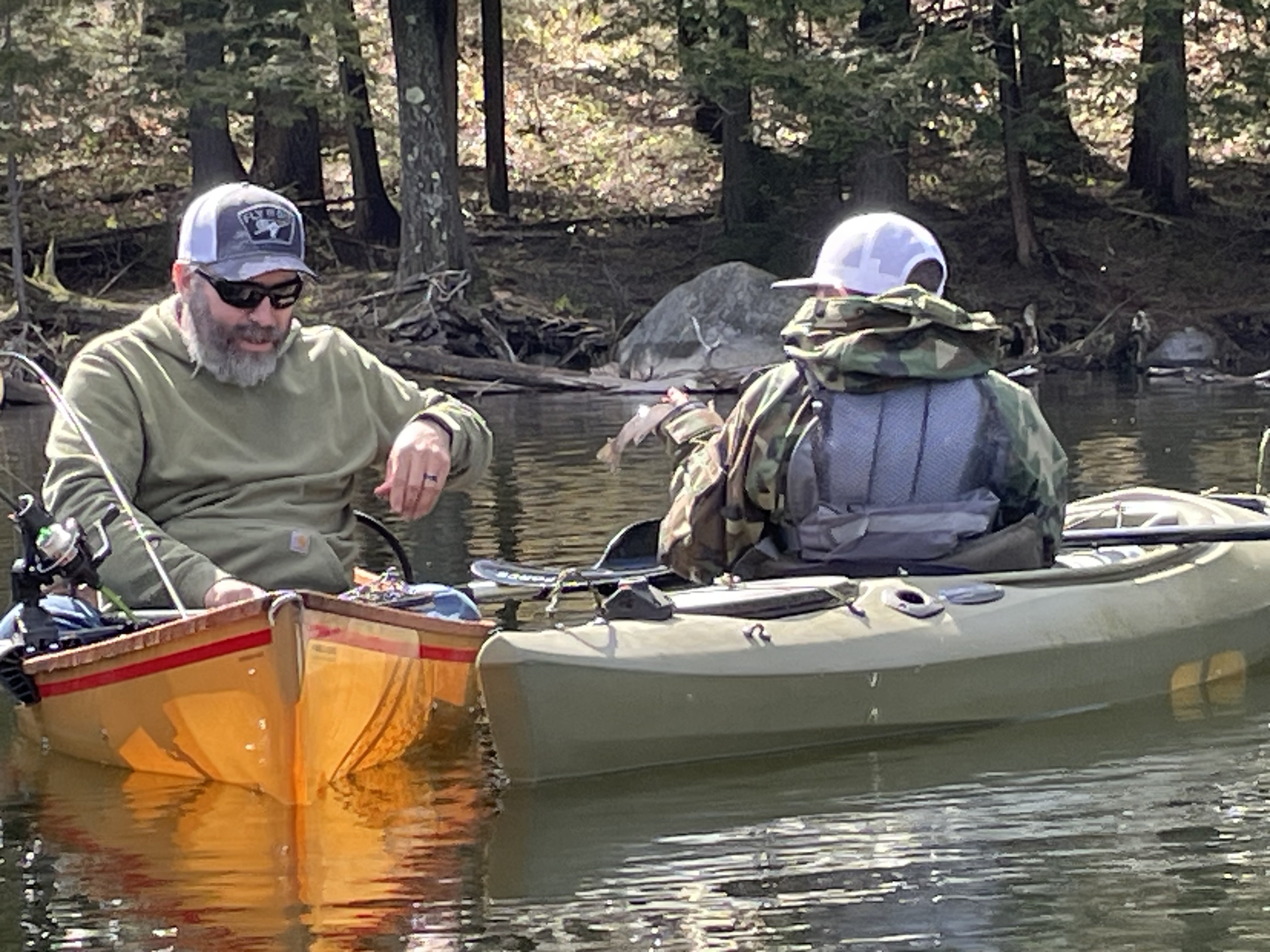 Two anglers in kayaks on Saranac River New York during fishing trip