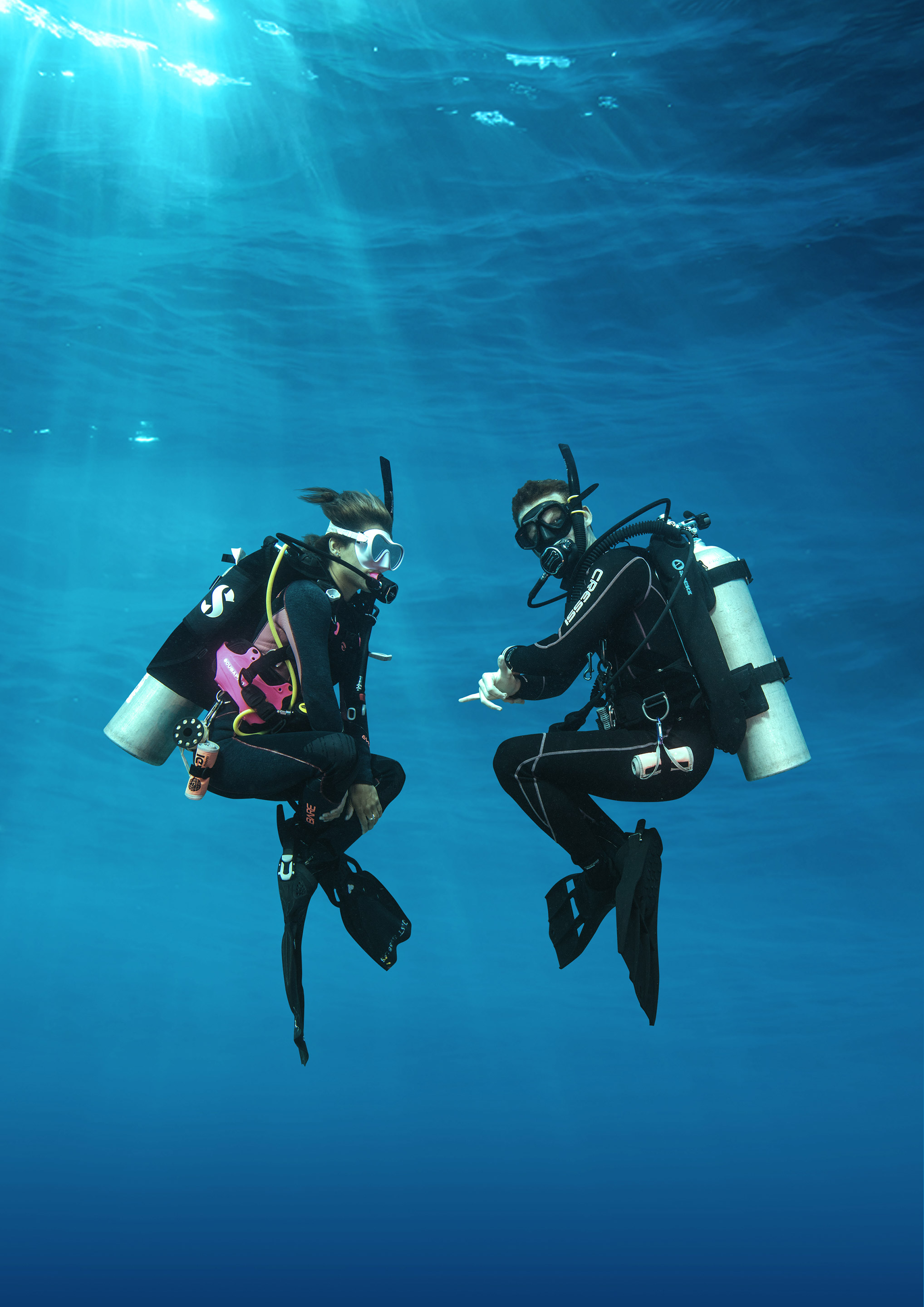 Two scuba divers underwater in blue ocean water near North Palm Beach FL