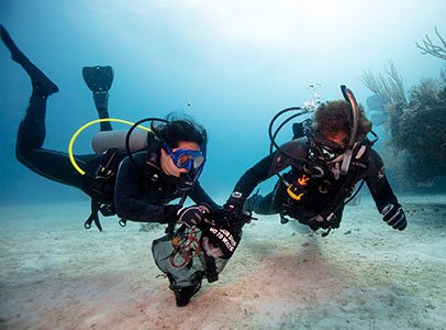 Scuba divers removing marine debris during PADI Dive Against Debris course West Palm Beach