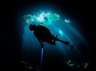 Night diving certification course West Palm Beach - scuba divers with underwater lights