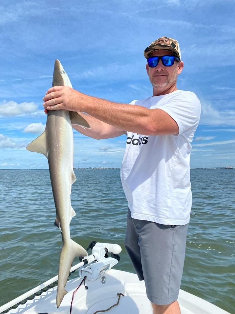 A person holding two big fish caught in SC