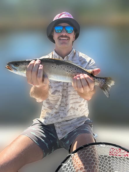 Angler holding freshly caught fish while fishing in Greenville NC