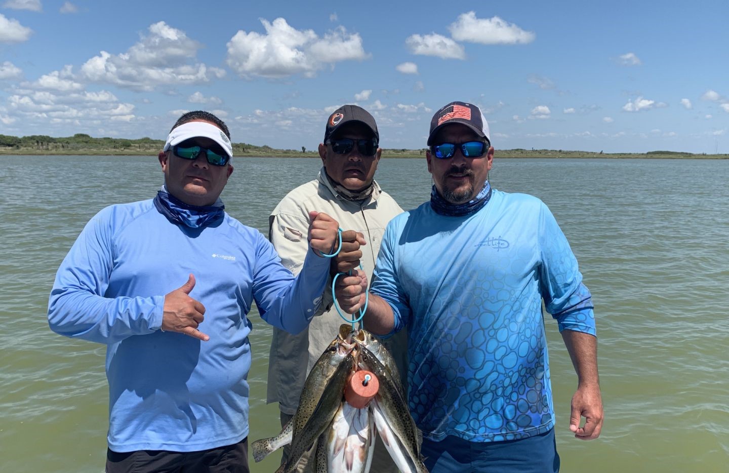 Three anglers fishing on the shore of South Padre Island