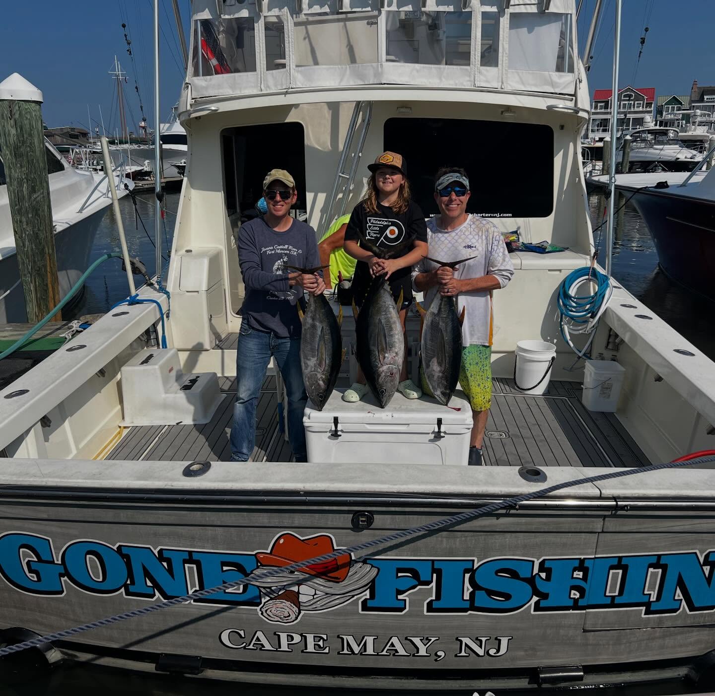 Three yellowfin tuna displayed on fishing boat deck at Cape May NJ marina