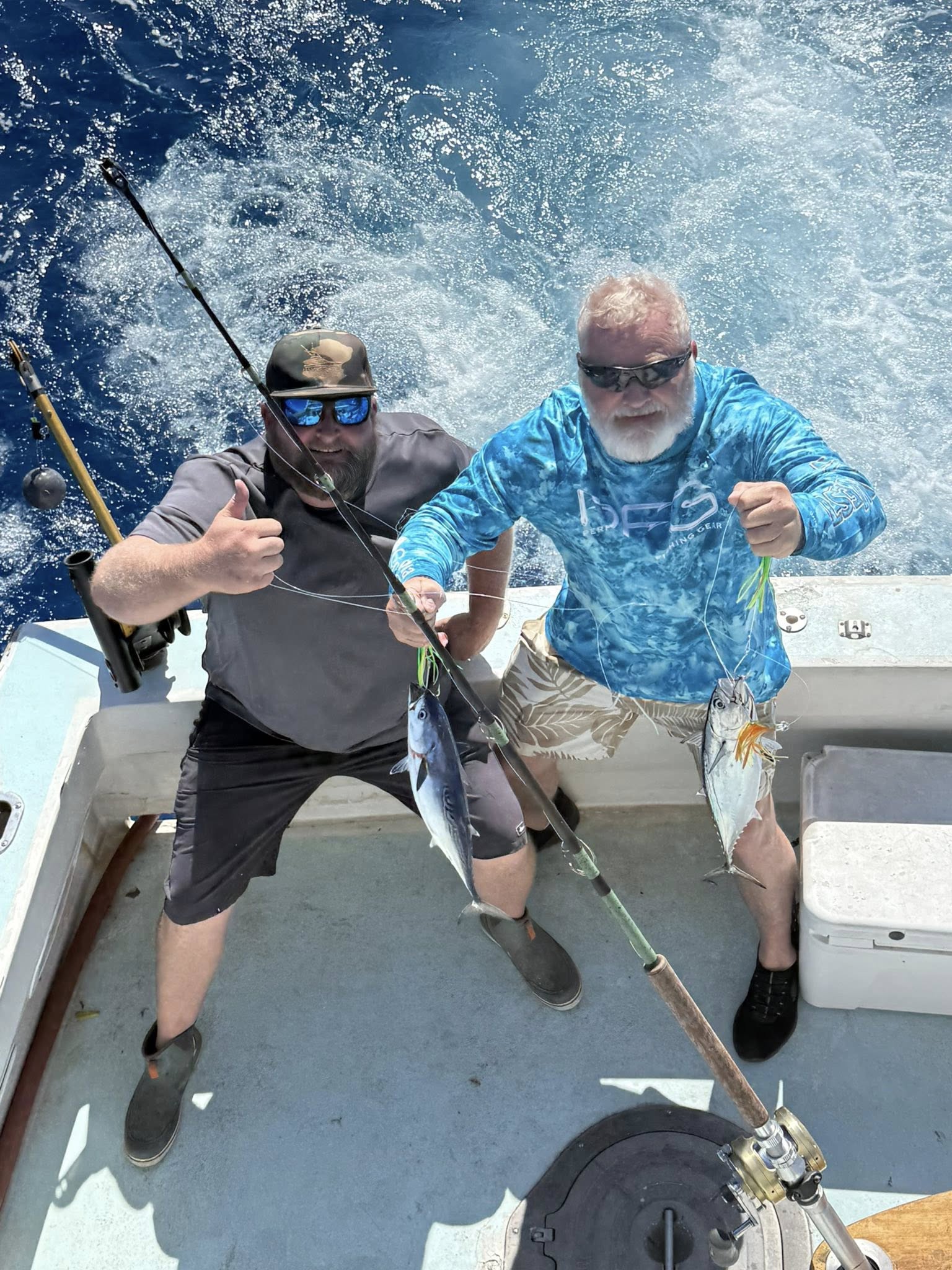 Two anglers on fishing boat displaying caught Little Tunny and second fish species in Key West FL waters