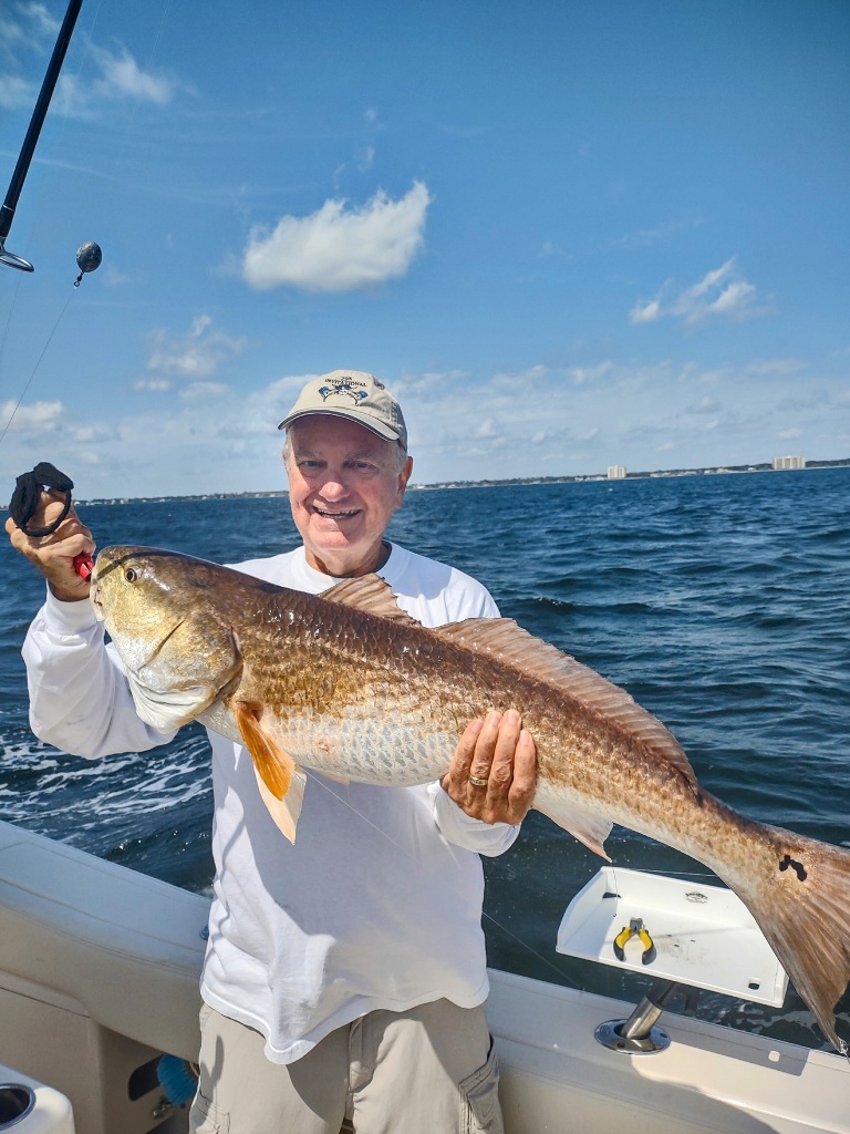 Angler holding a 30-inch fish in Pensacola