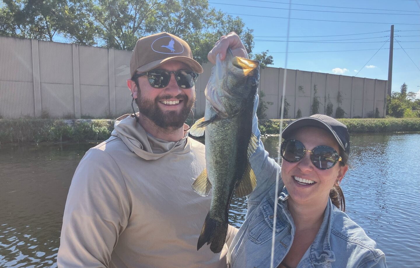 Anglers displaying freshly caught bass while fishing in Fort Lauderdale FL