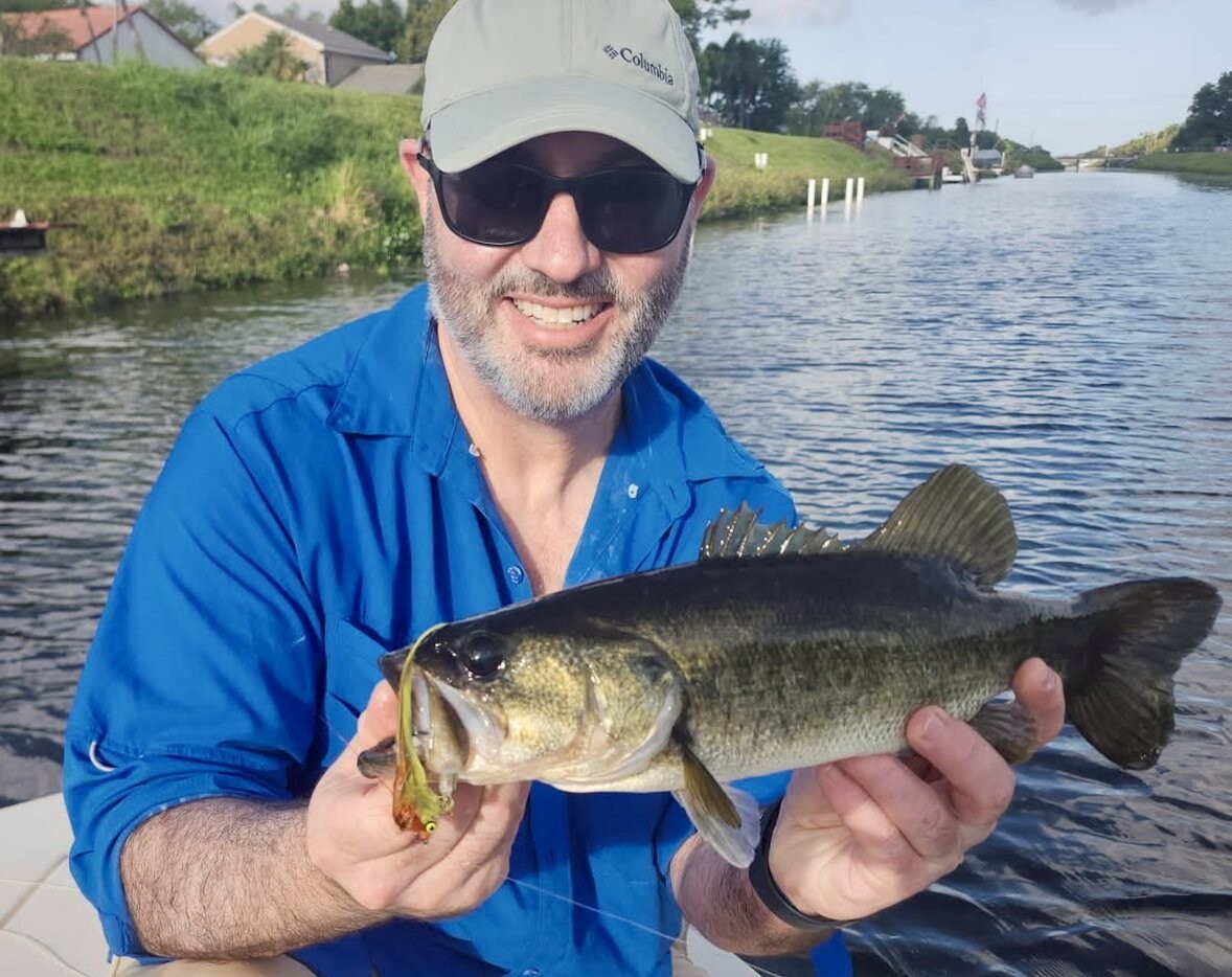 Largemouth bass caught while fishing in Fort Lauderdale FL with lure visible